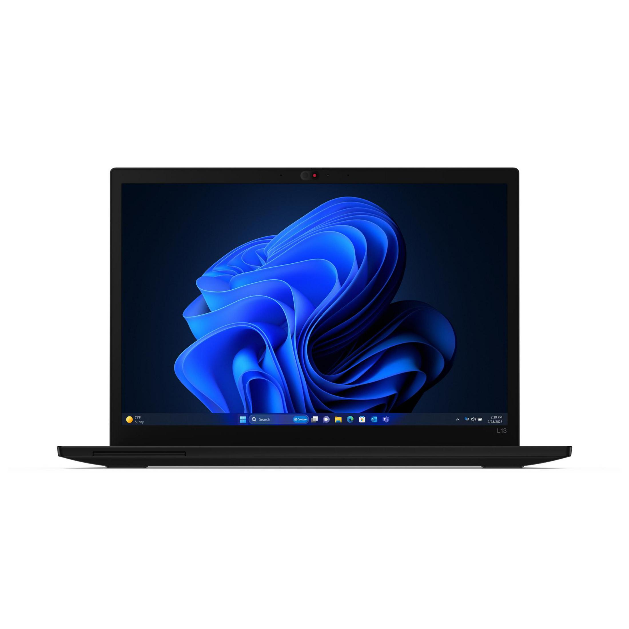 Un laptop nero mostra uno sfondo del desktop blu e scuro. Il laptop è su una superficie bianca.