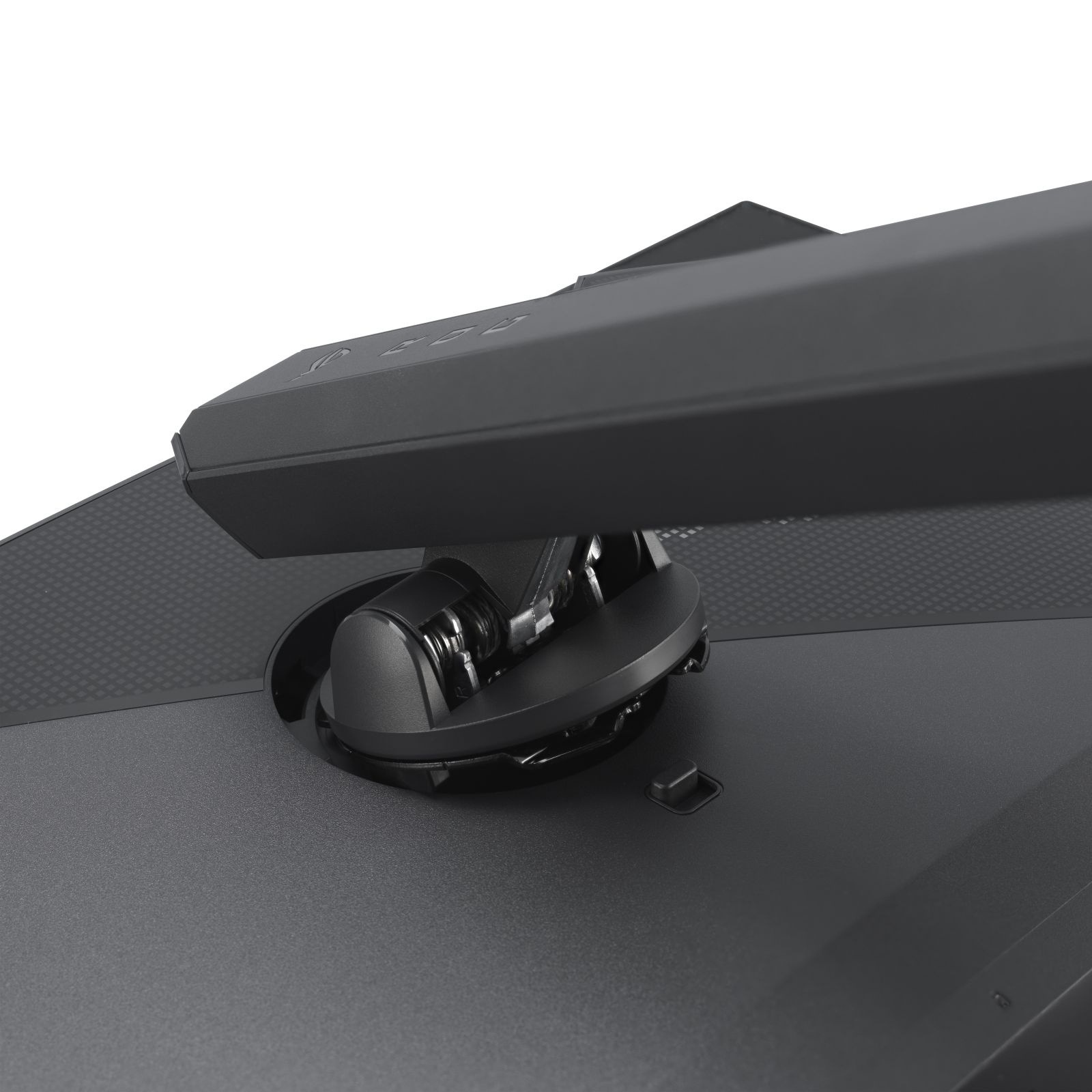 Zbliżenie czarnej podstawy i ramienia monitora z okrągłą podstawą. Podstawa jest zamontowana na teksturowanej powierzchni.