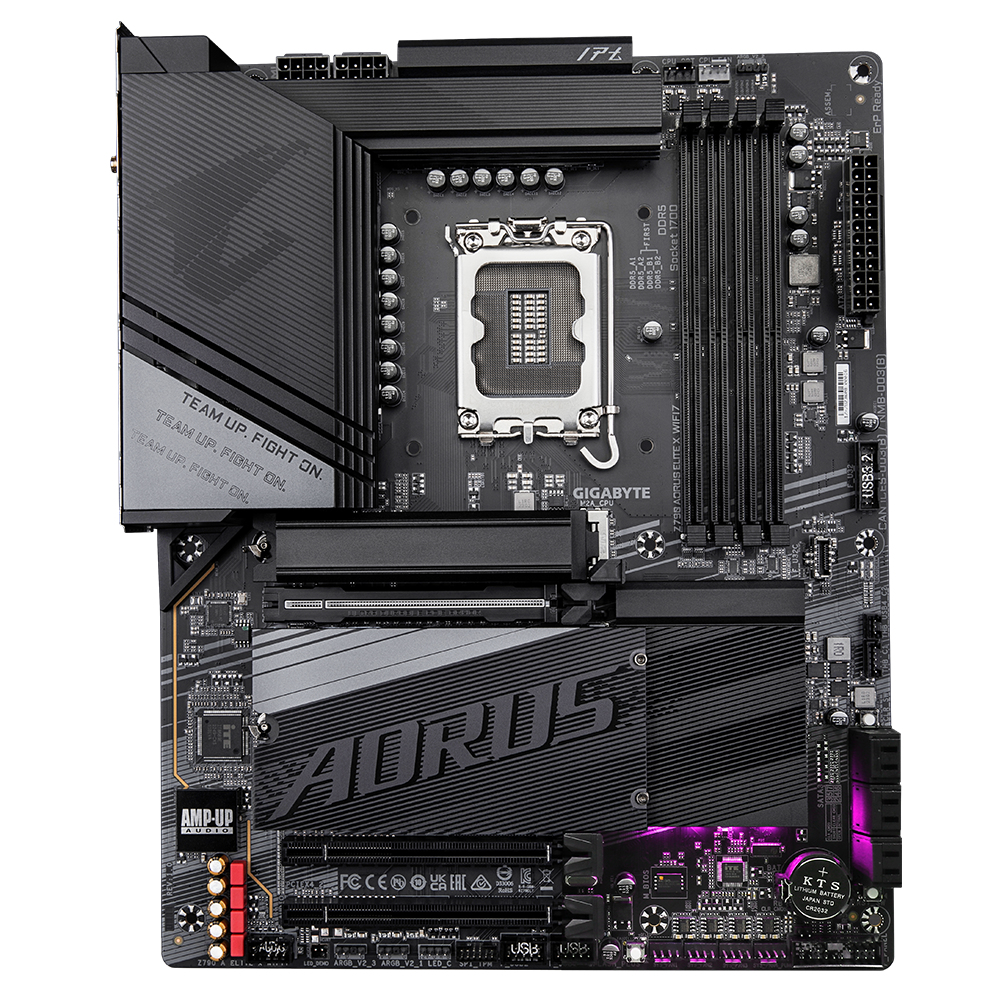 Una scheda madre Gigabyte AORUS nera e grigia. Include socket CPU, slot RAM e vari connettori. Il testo dice 'TEAM UP. FIGHT ON'.