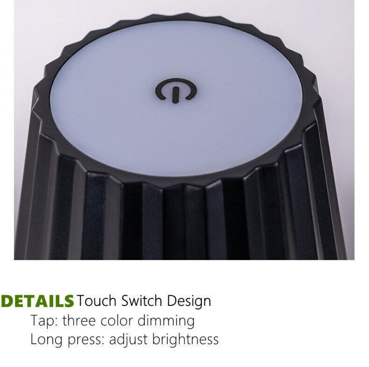 Eine schwarze Touch-Lampe mit einem Ein-Aus-Symbol oben. Sie hat ein zylindrisches Design mit geriffelten Seiten und einer hellgrauen Oberseite.