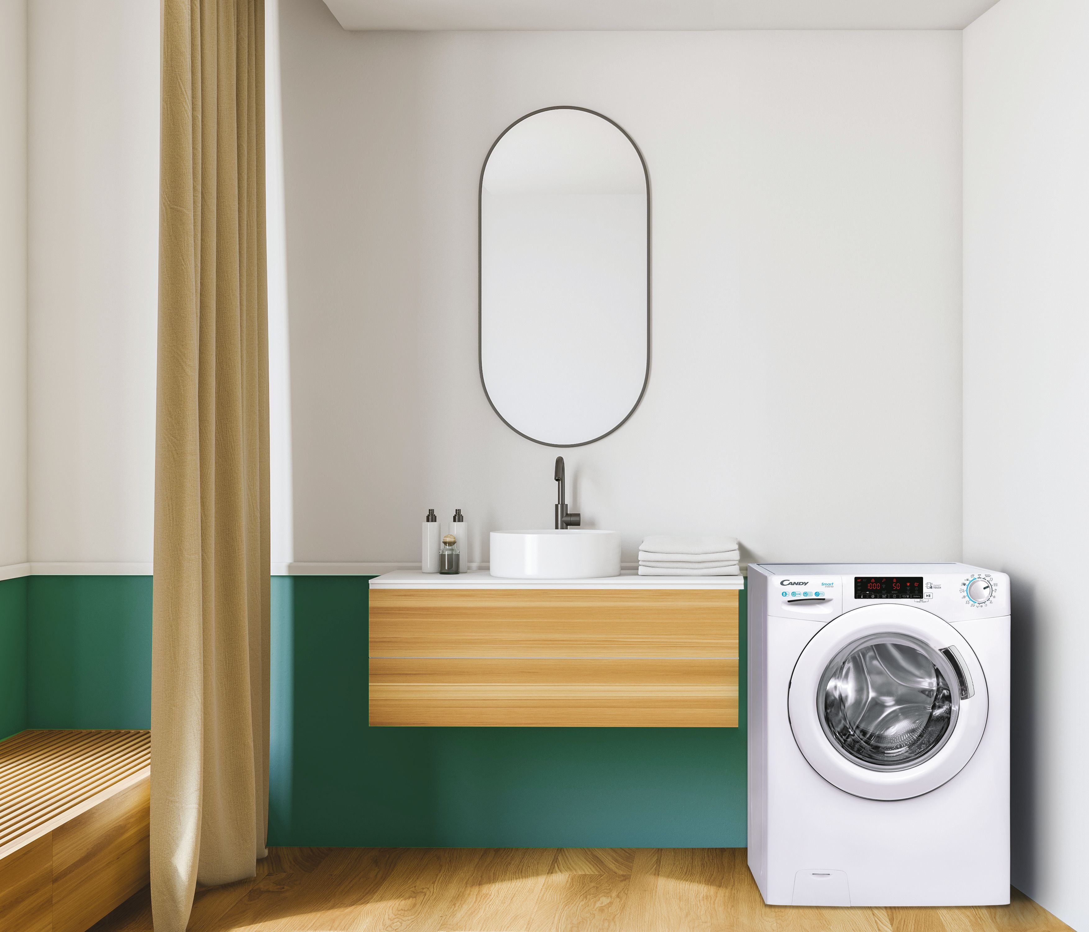 Bagno con lavatrice bianca, mobile in legno, specchio ovale e parete verde. Una tenda a sinistra.