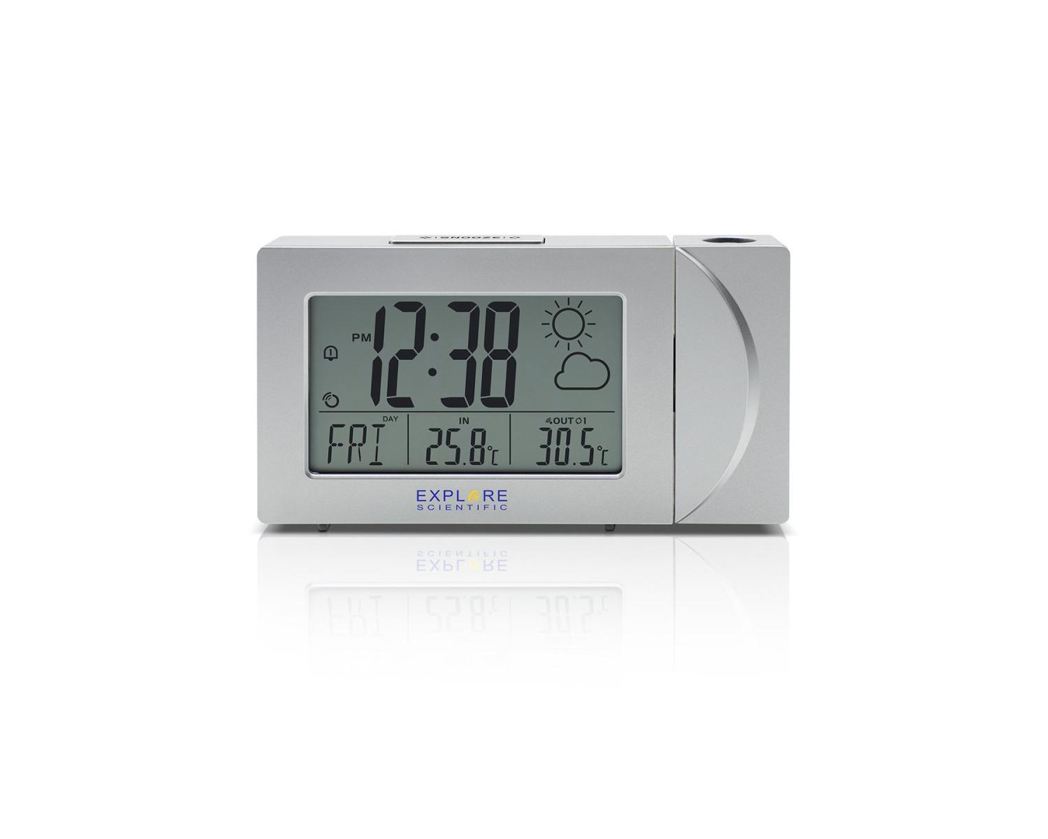 Un orologio digitale argentato mostra le 12:38 PM, venerdì e le temperature. Ha un'icona meteo e il logo Explore Scientific.