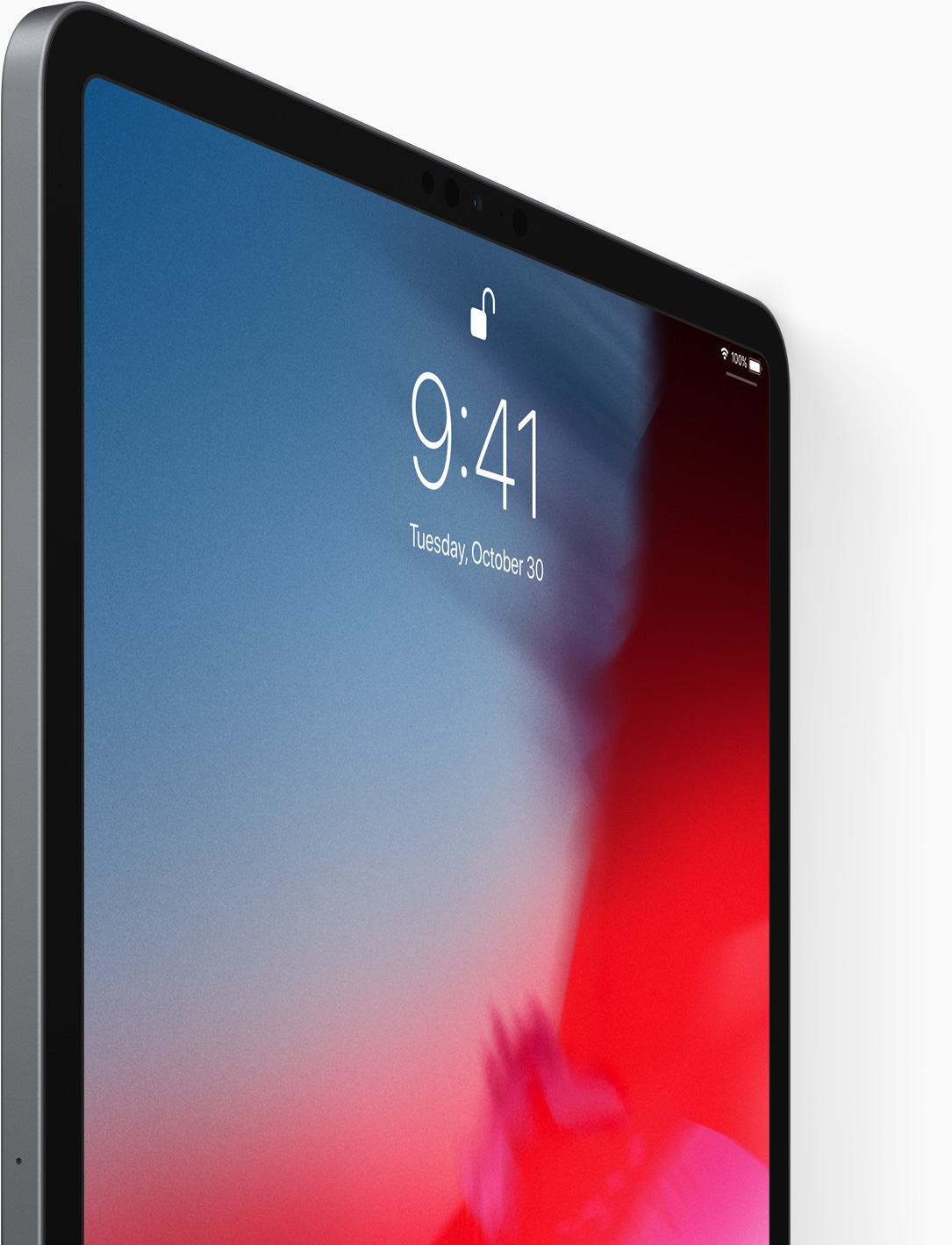 Gros plan sur un écran d'iPad affichant l'heure 9:41, la date et un symbole de chargement. Le fond est dégradé bleu à rouge.