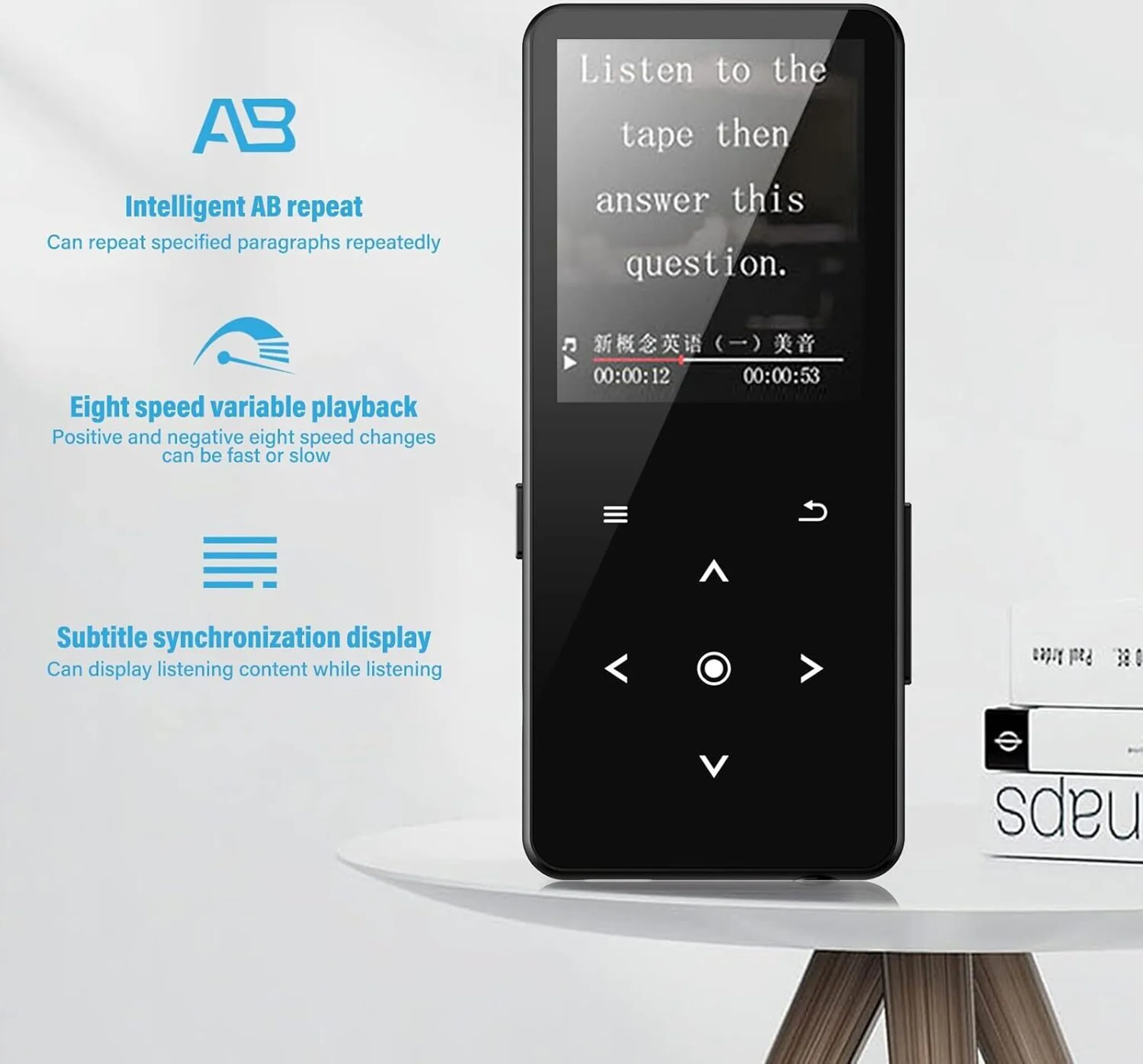 Schwarzer MP3-Player auf weißem Tisch. Text auf dem Bildschirm. Bücher liegen neben dem Player.