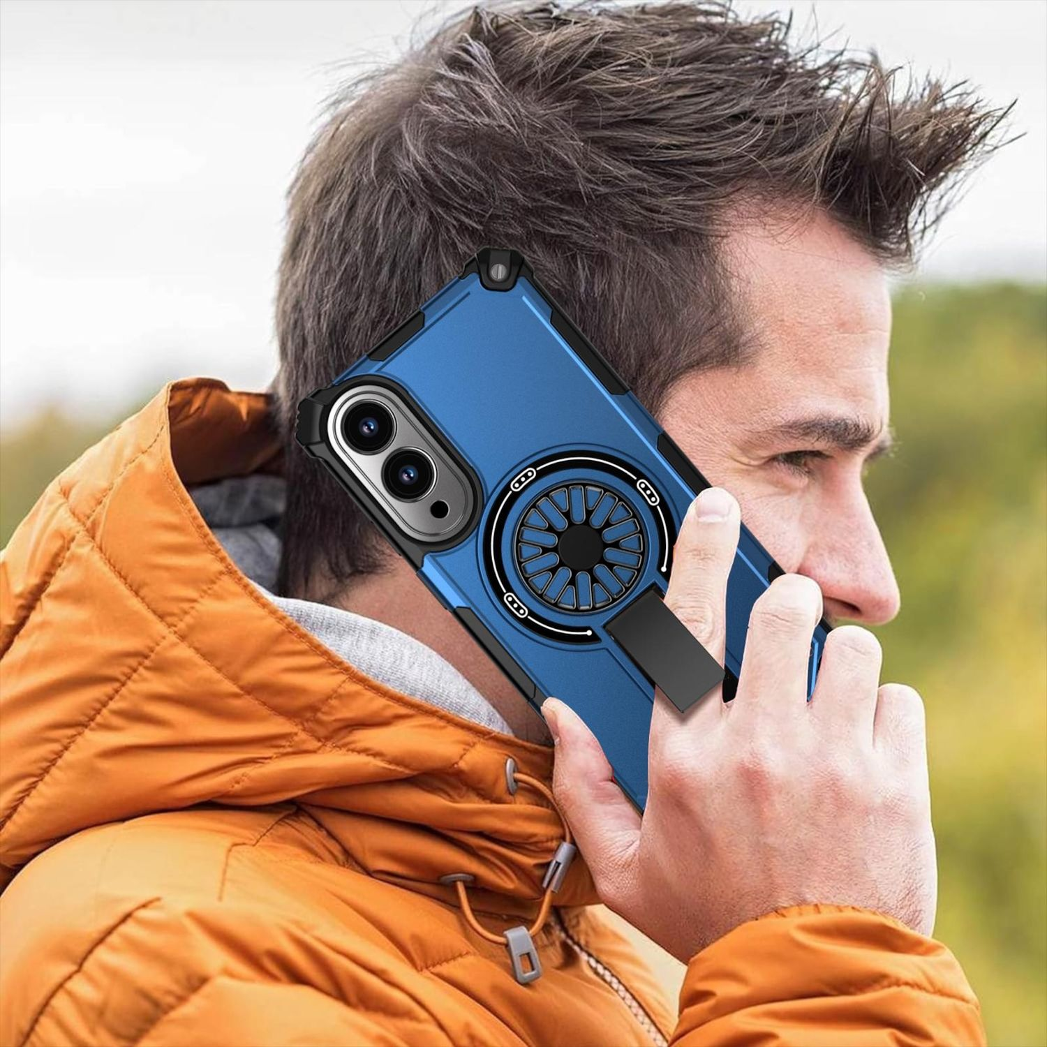 Mann hält ein Telefon mit blauem Gehäuse an sein Ohr. Er trägt eine orangefarbene Jacke. Die Handyhülle hat einen schwarzen Ständer.