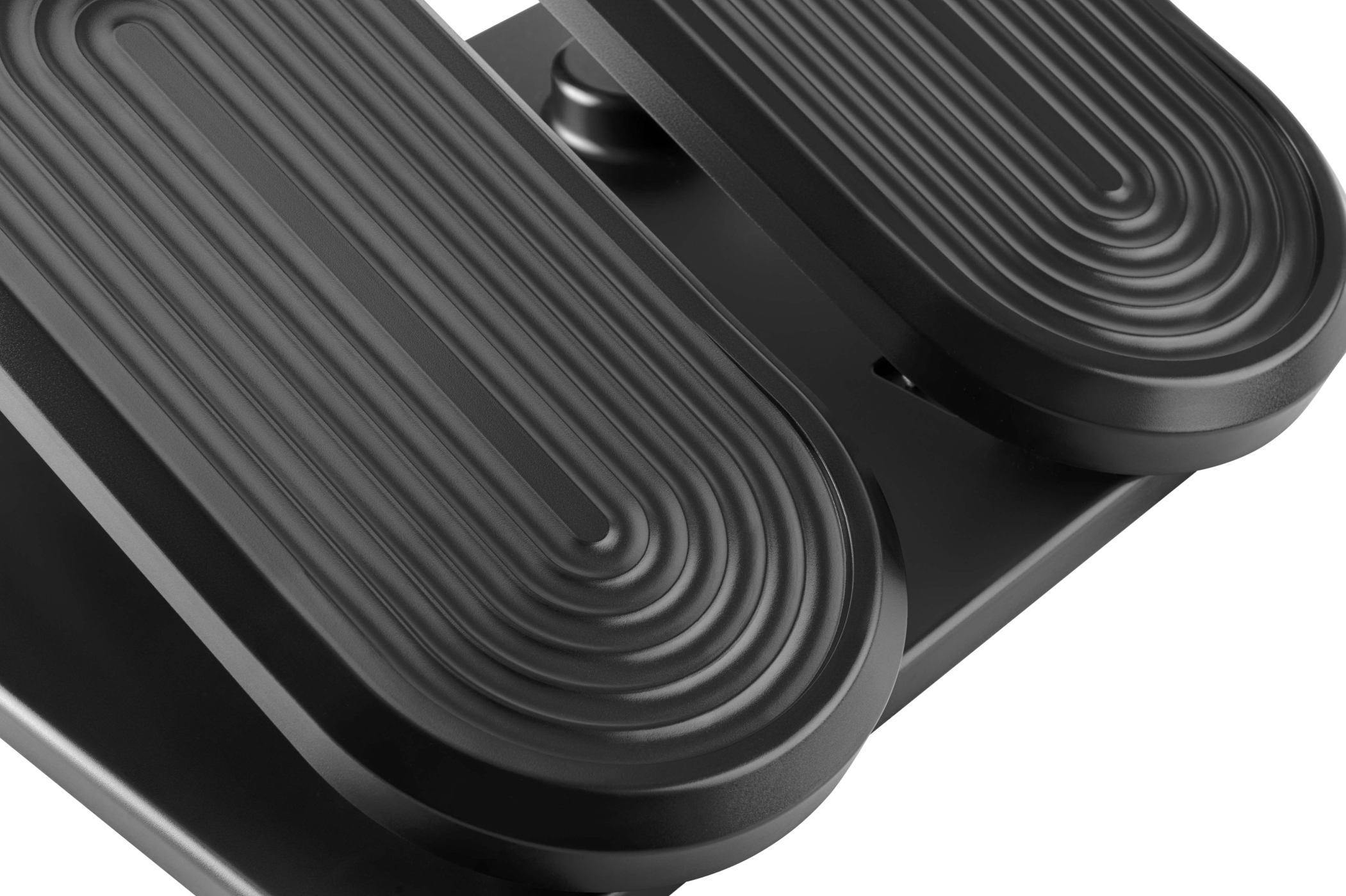 Close-up of black foot pedals. Each has a ribbed surface and a curved, oval shape. Background is white.