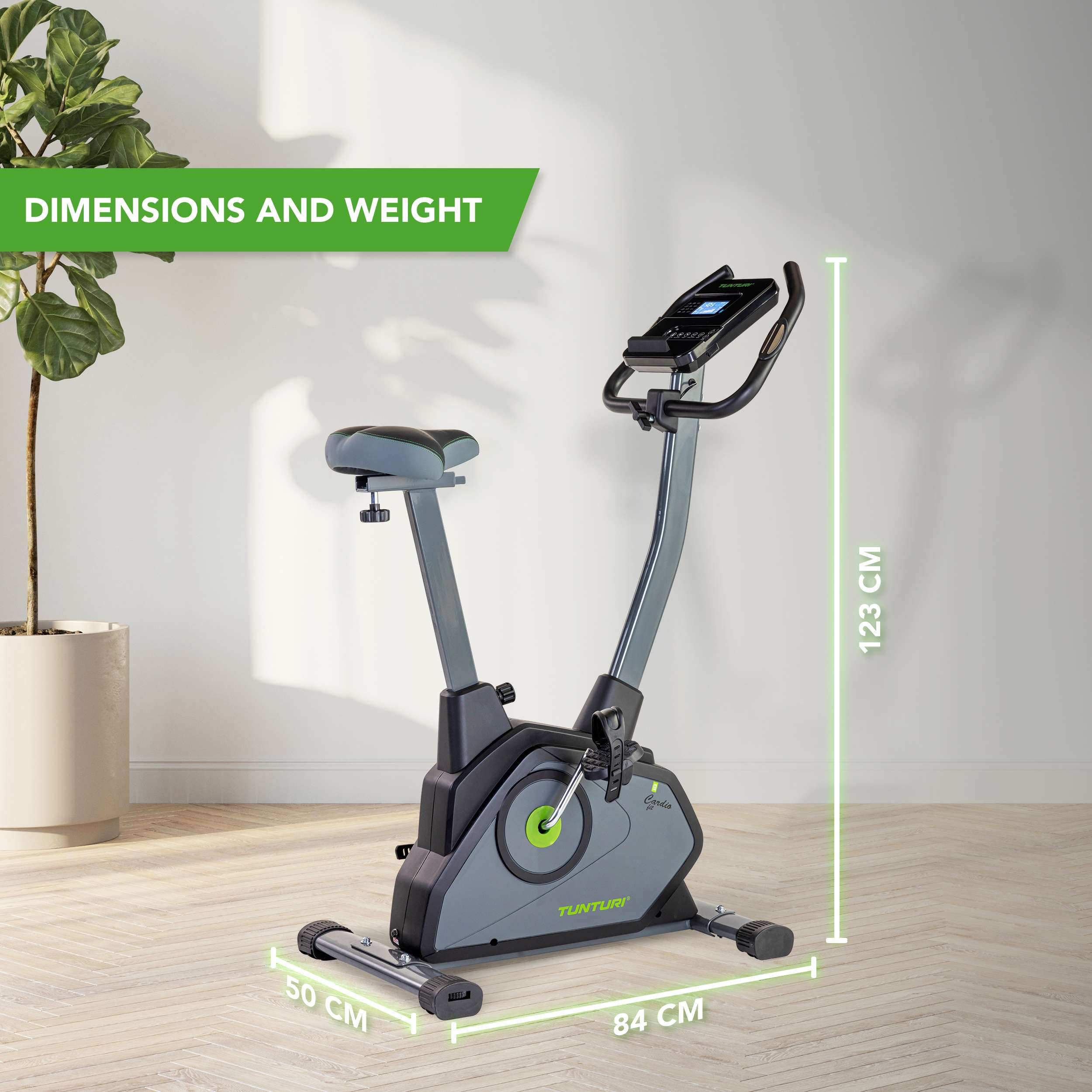 An exercise bike with dimensions displayed, near a potted plant, on a wooden floor, against a white wall.
