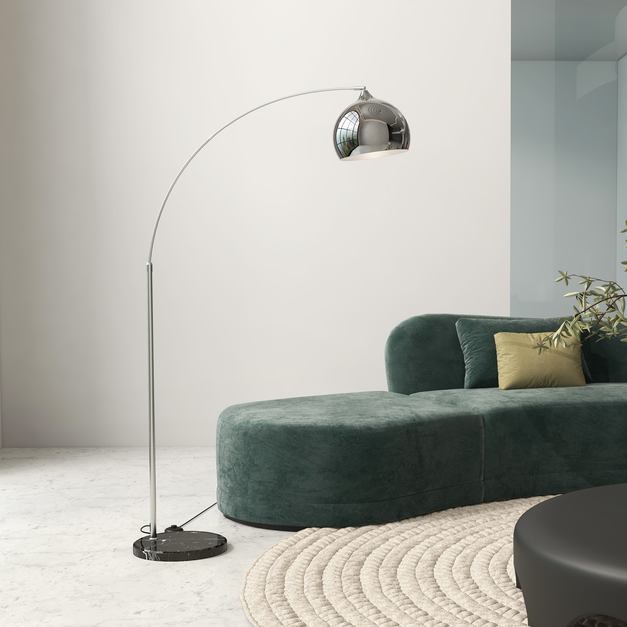 Un salón moderno con sofá verde, lámpara plateada, alfombra y mesa negra.
