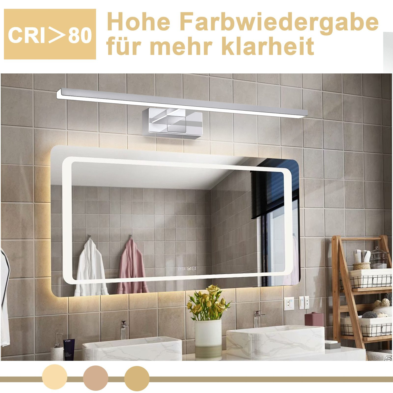 Bagno con specchio illuminato, lavandino e lampada sopra lo specchio. Un asciugamano appeso e un vaso di fiori sul lavandino.