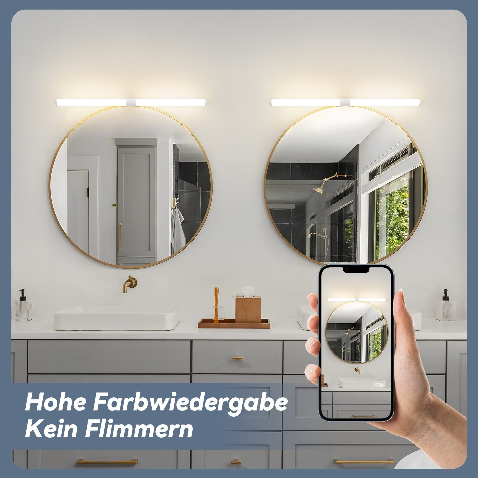 Un bagno con due specchi rotondi, una persona che tiene un telefono che mostra lo specchio. Armadi grigi, lavandini bianchi e finiture dorate.