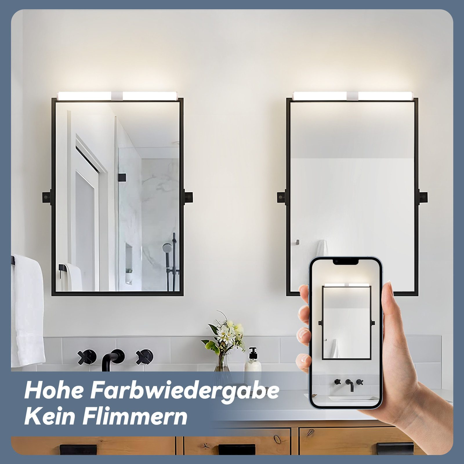 Un bagno con due specchi con luci sopra. Un telefono mostra uno specchio. Sotto, rubinetti, fiori e sapone sono visibili.