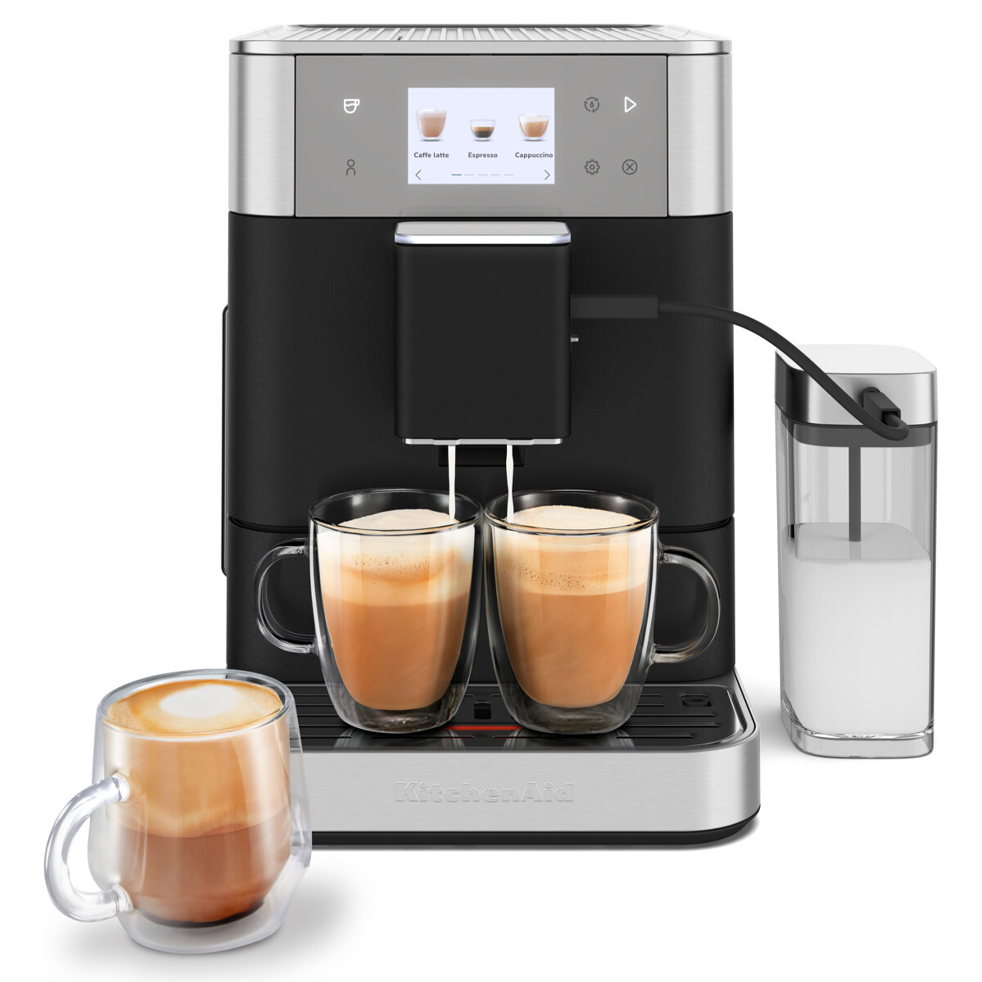 Gümüş ve siyah bir KitchenAid espresso makinesi, iki kahve kupası ve bir şeker dağıtıcısı. Kahve dağıtılıyor.