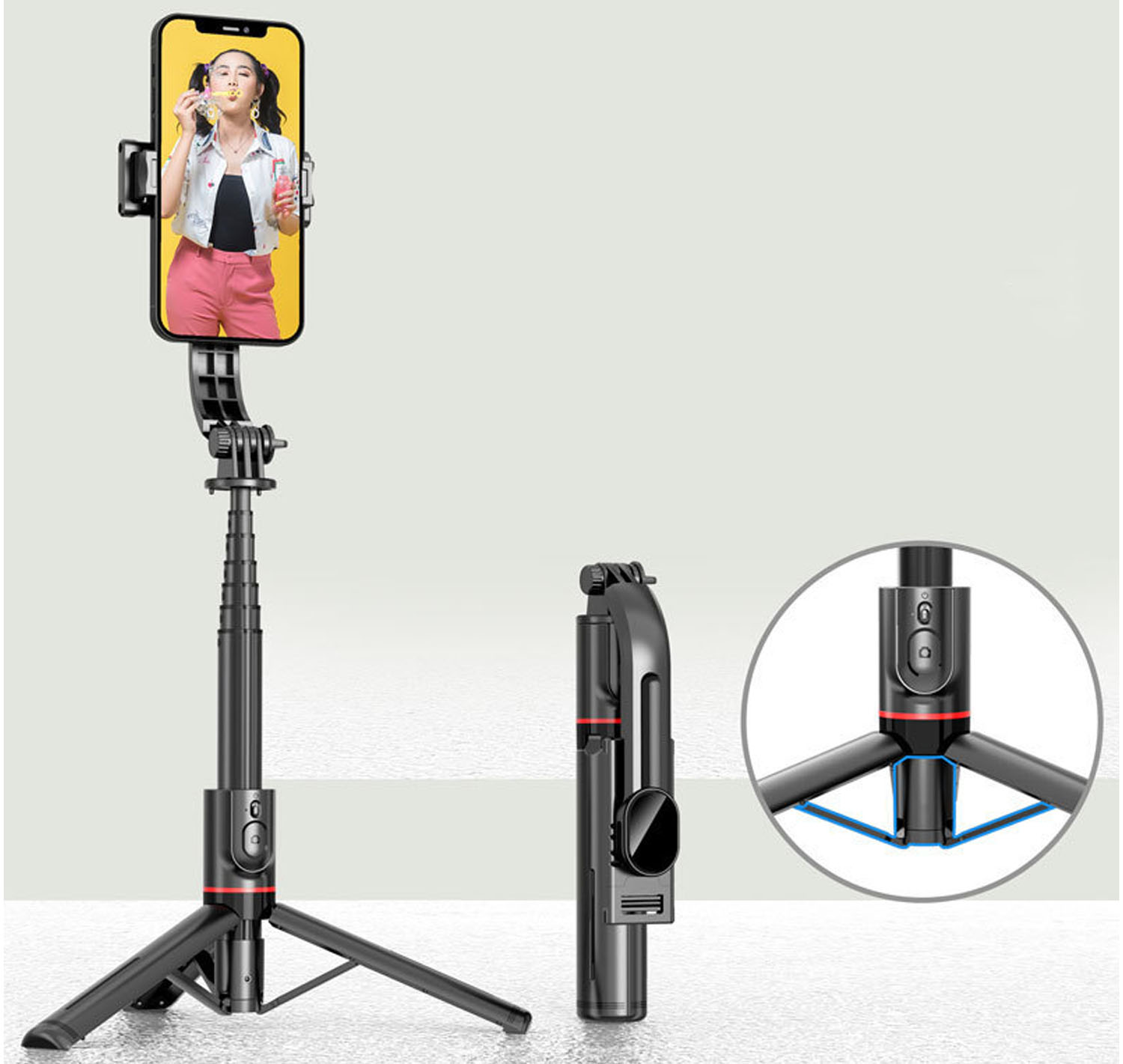 Ein schwarzer Selfie-Stick mit einem Telefon, das eine Frau beim Blasen von Blasen zeigt. Ein gefalteter Stick und ein Stativ werden ebenfalls gezeigt. Der Hintergrund ist hellgrau.