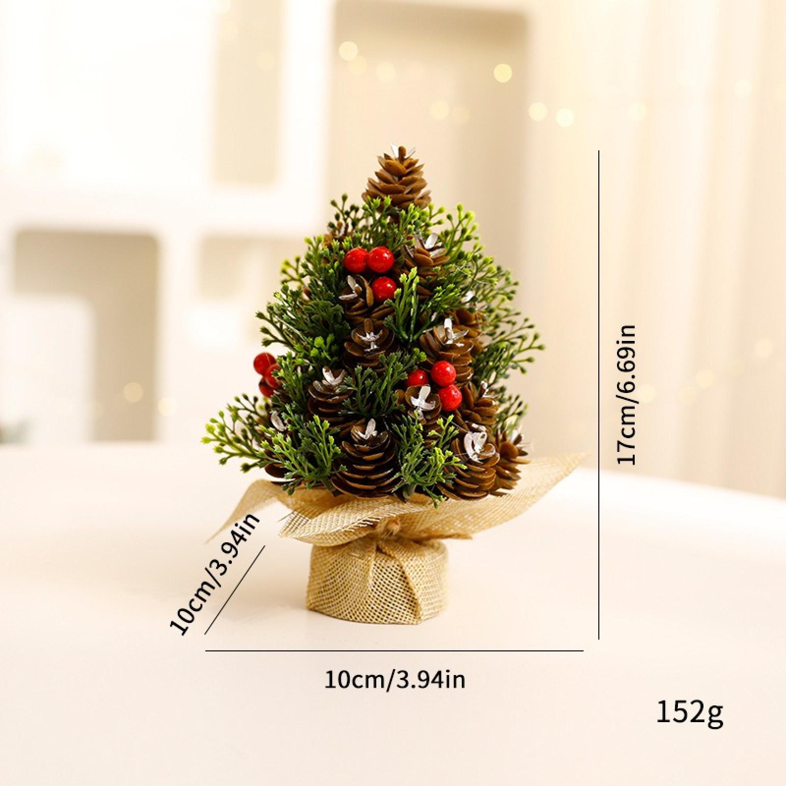Ein kleiner künstlicher Weihnachtsbaum mit Tannenzapfen und roten Beeren. Er steht auf einem Untergrund aus Jute, mit Größen- und Gewichtsangaben.