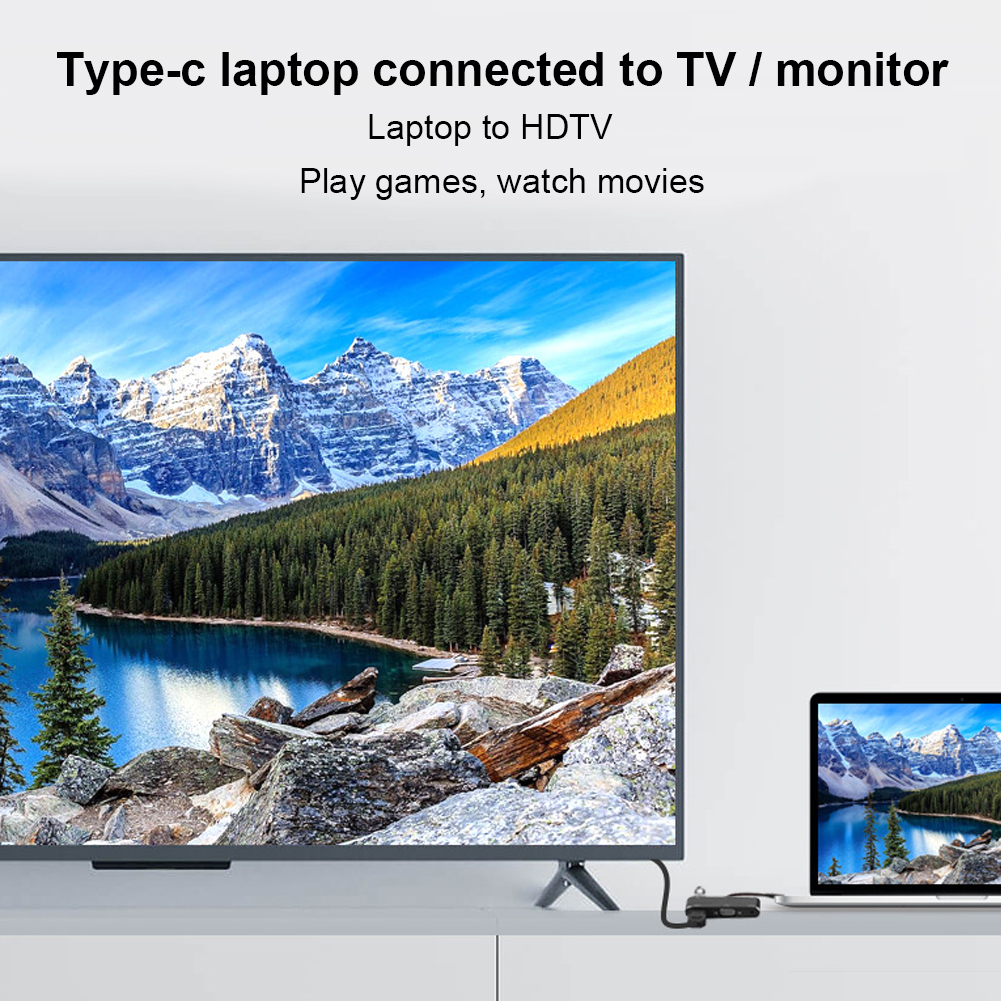 Ein Laptop, der an einen Fernseher angeschlossen ist, zeigt eine Landschaft mit Bergen und einem See. Der Text lautet 'Laptop zu HDTV, Spiele spielen, Filme ansehen'.
