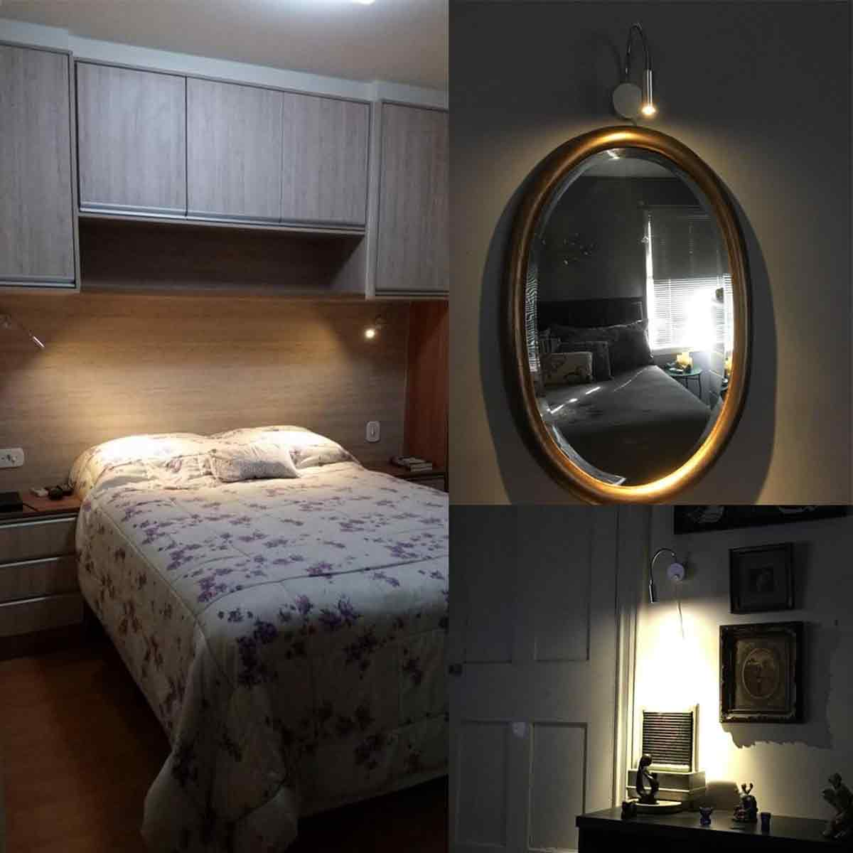 Schlafzimmer mit Bett, floraler Bettdecke, Holzschränken, ovalem Spiegel und Kunst. Weiche Beleuchtung erhellt den Raum.