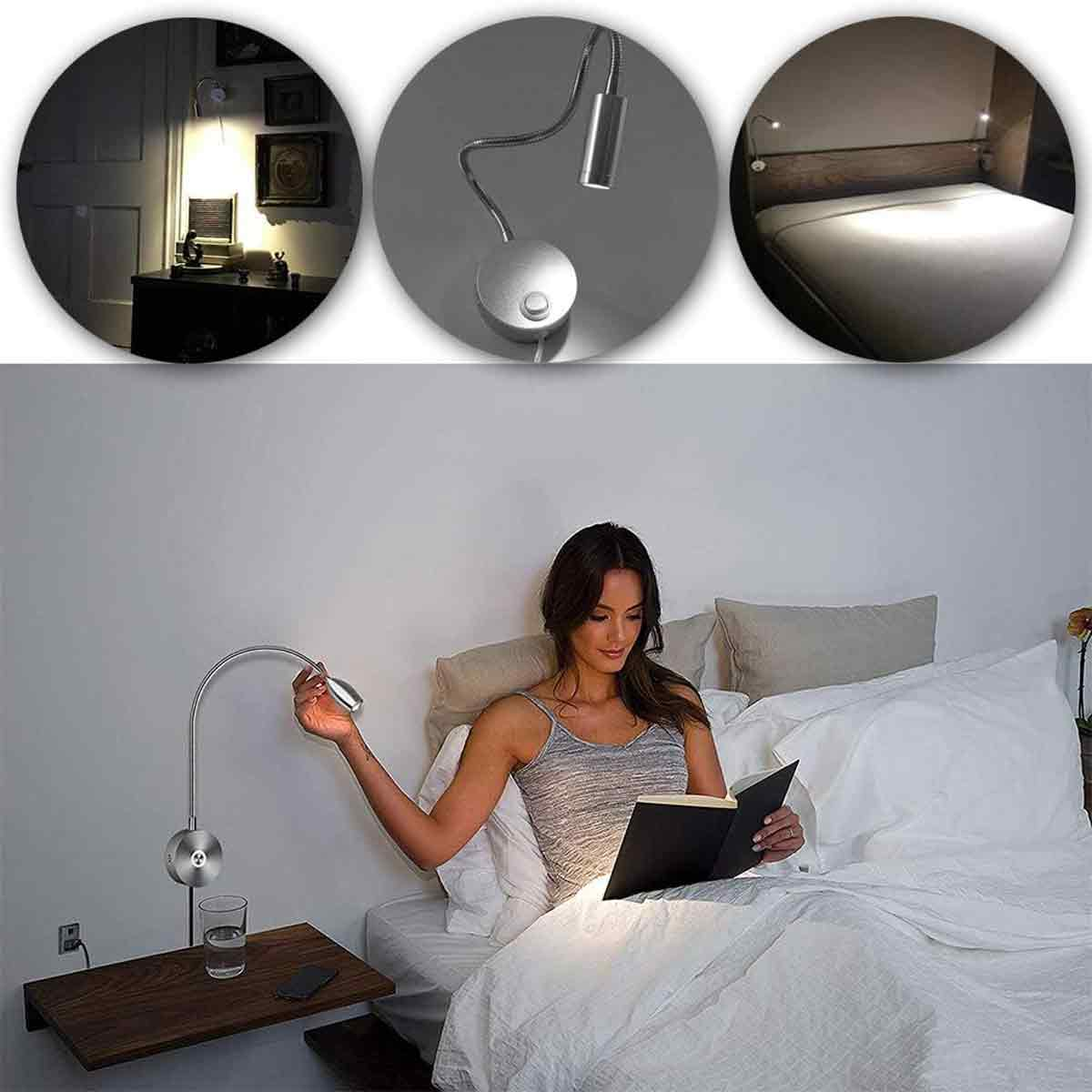 Eine Frau liest im Bett unter einer Nachttischlampe. Ein Glas Wasser, ein Telefon und ein Holzregal sind neben ihr. Die Bettwäsche ist weiß.