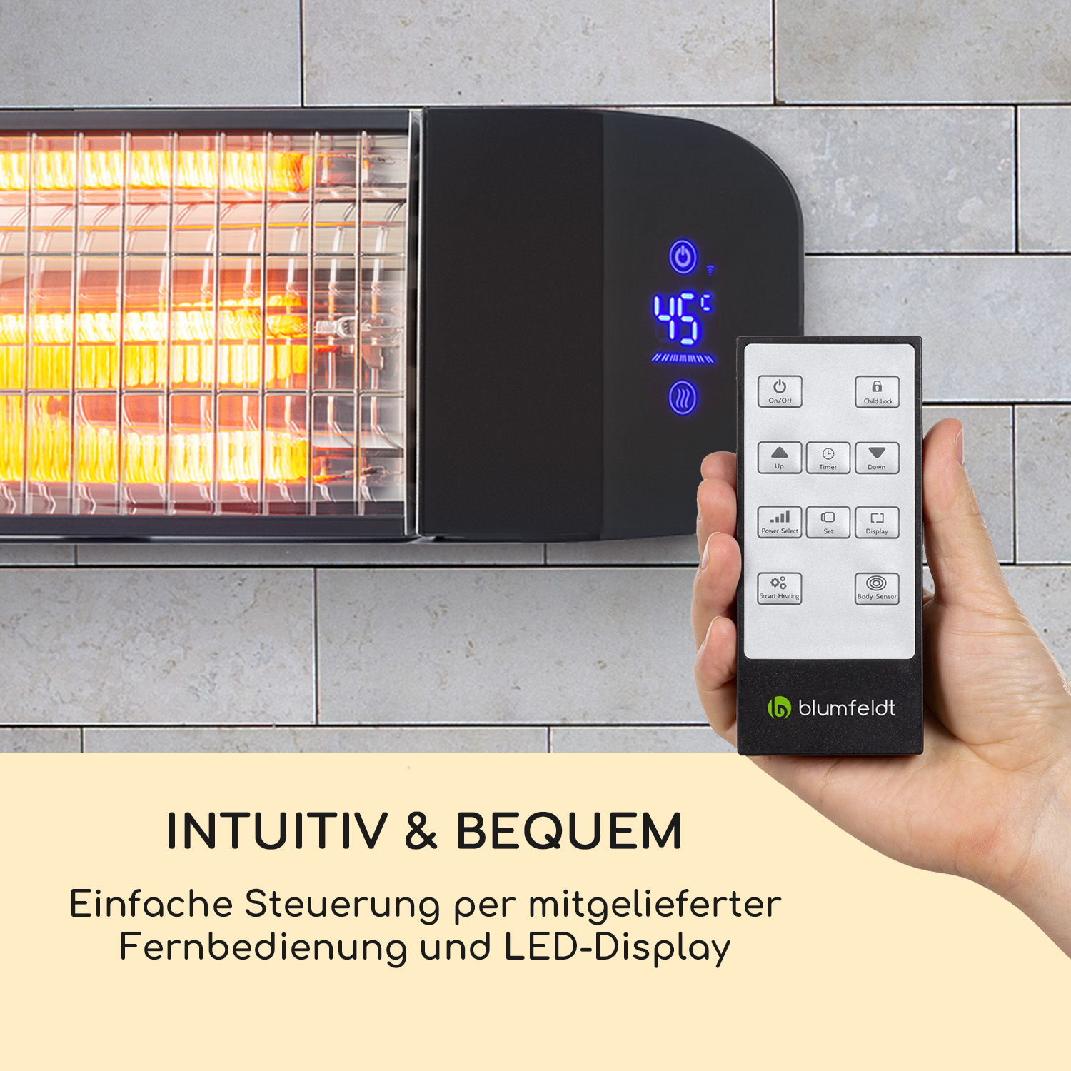 Ein schwarzer Heizkörper mit Fernbedienung wird in der Hand gehalten. Er zeigt eine Temperatur von 45 Grad an. Der Heizkörper ist an einer gefliesten Wand montiert.