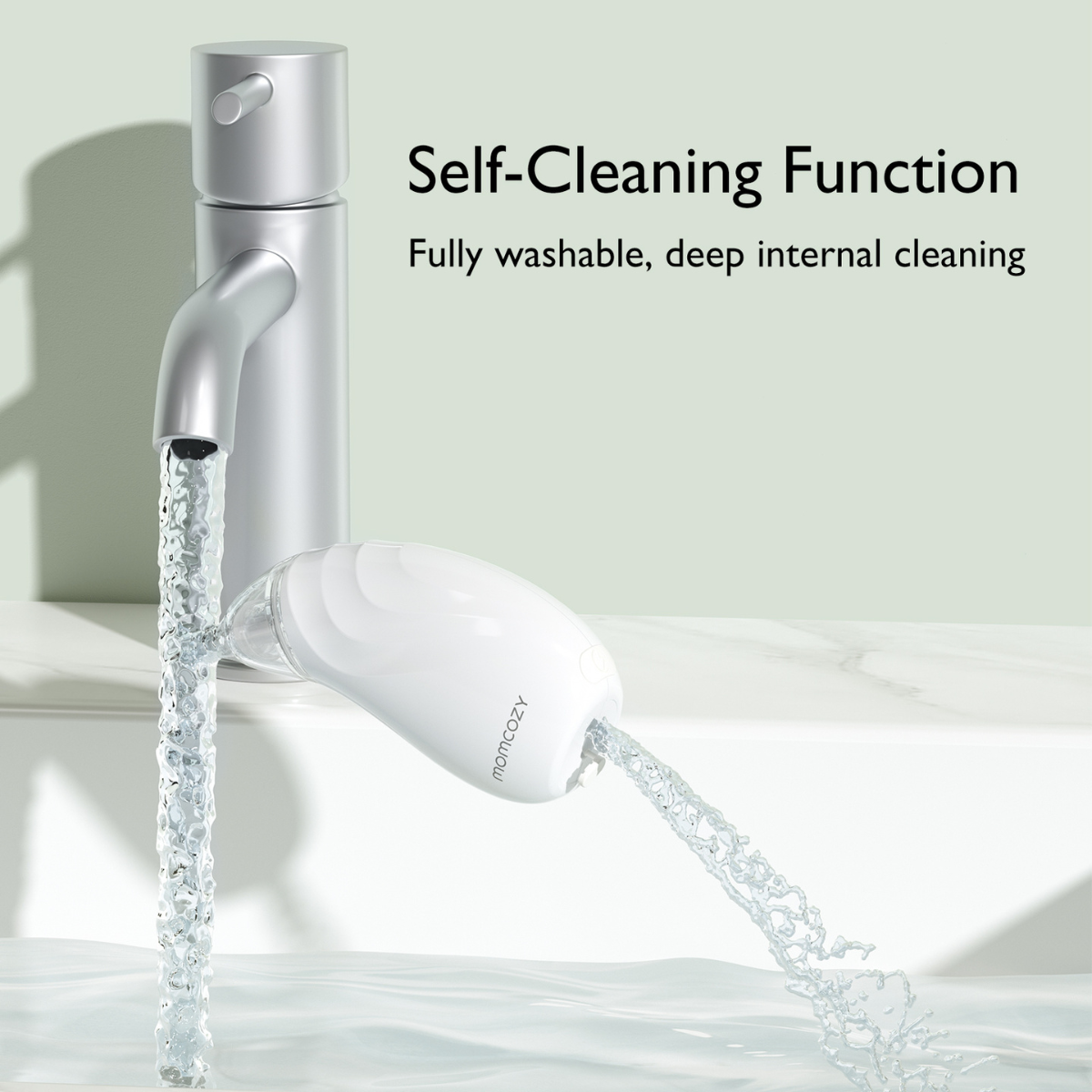 A faucet with water flowing into a white device. The device is labeled momcozy. Text reads 'Self-Cleaning Function'.