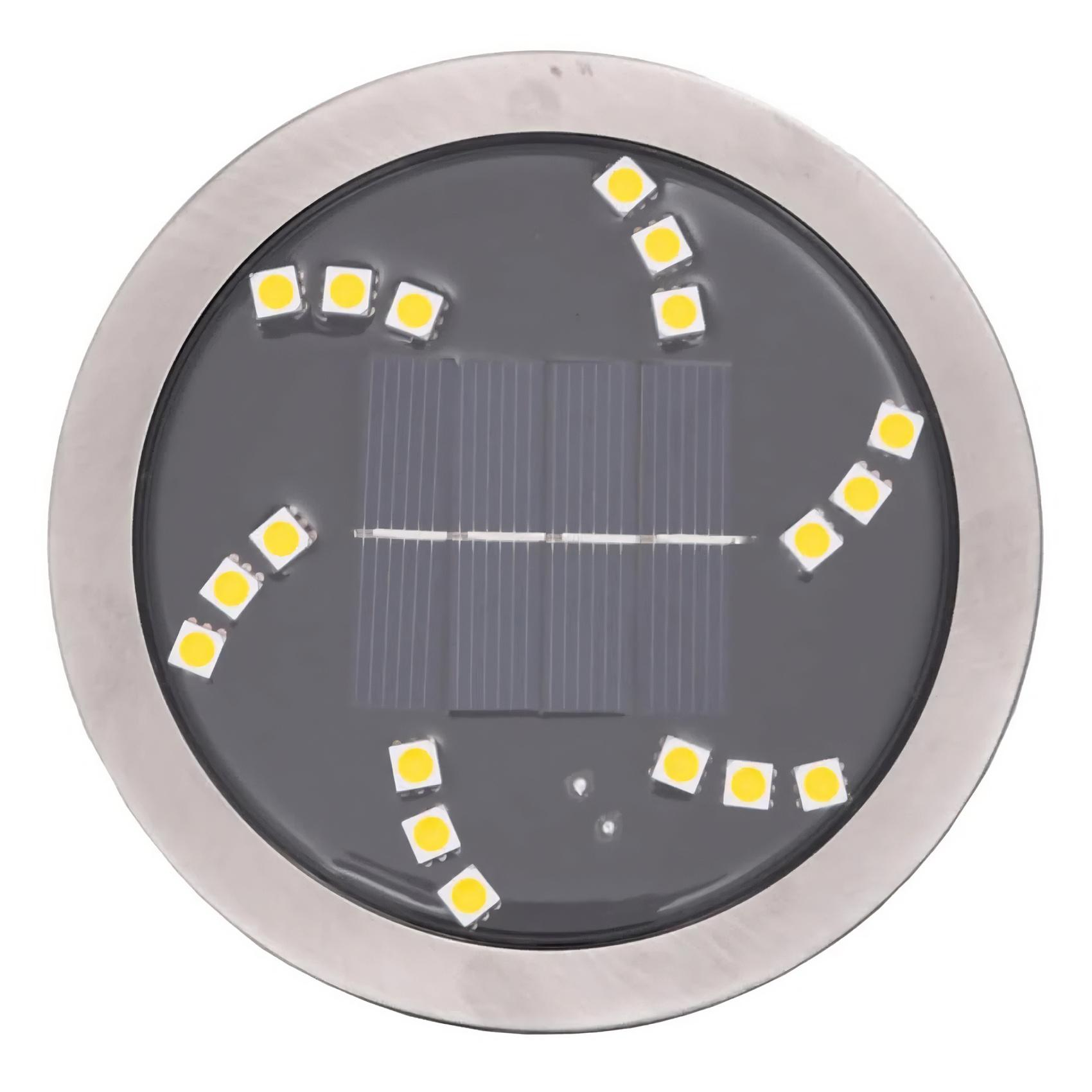Rundes Solarlicht mit silbernem Rand. Es hat eine dunkle Mitte mit Sonnenkollektoren und gelben LED-Leuchten am Rand.