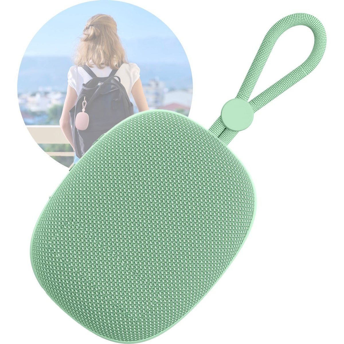 A mint green portable speaker with a loop handle. A woman with a backpack is in the background.