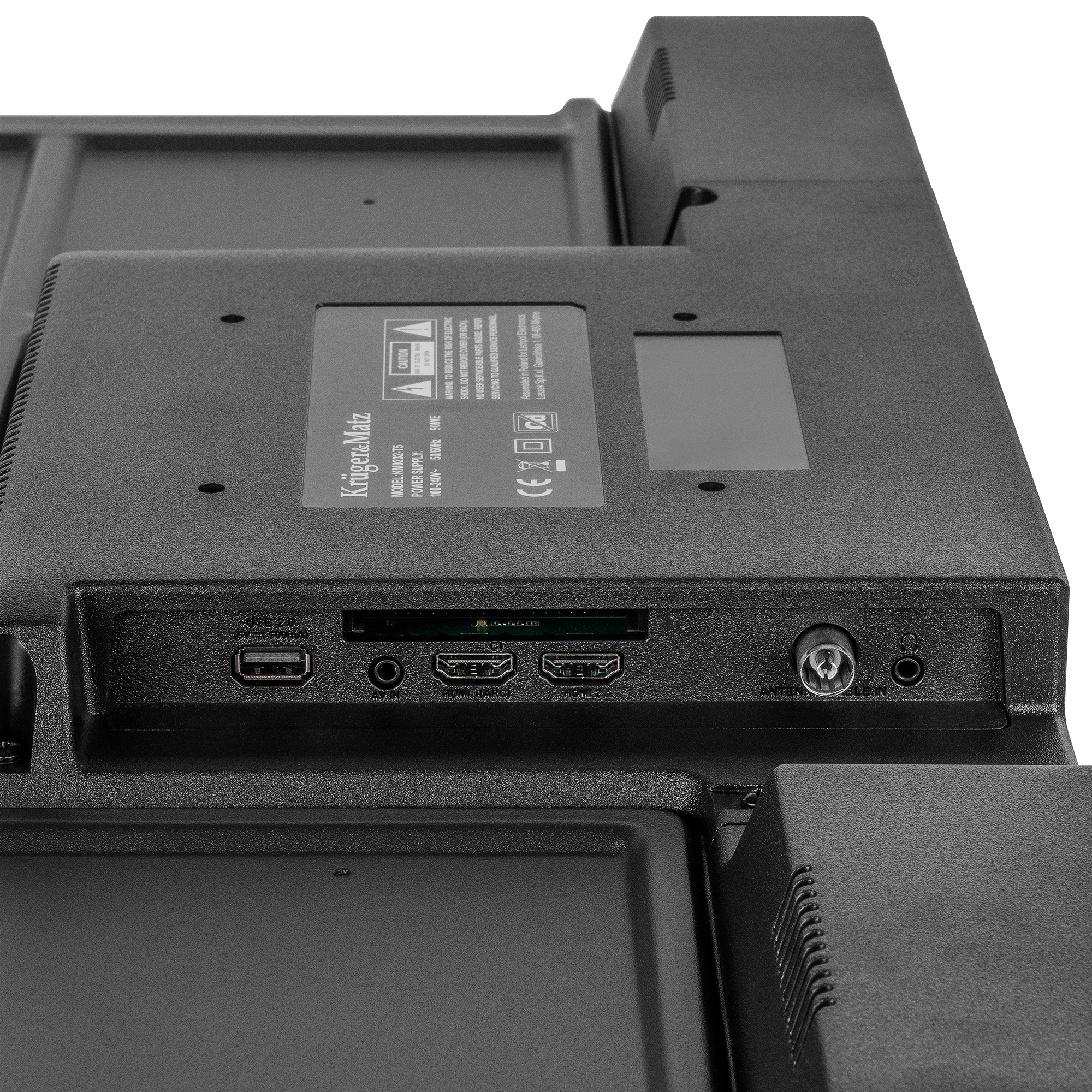 Panel tylny telewizora. Posiada porty, etykiety i informacje producenta. Czarny kolor z teksturowaną powierzchnią, białe tło.