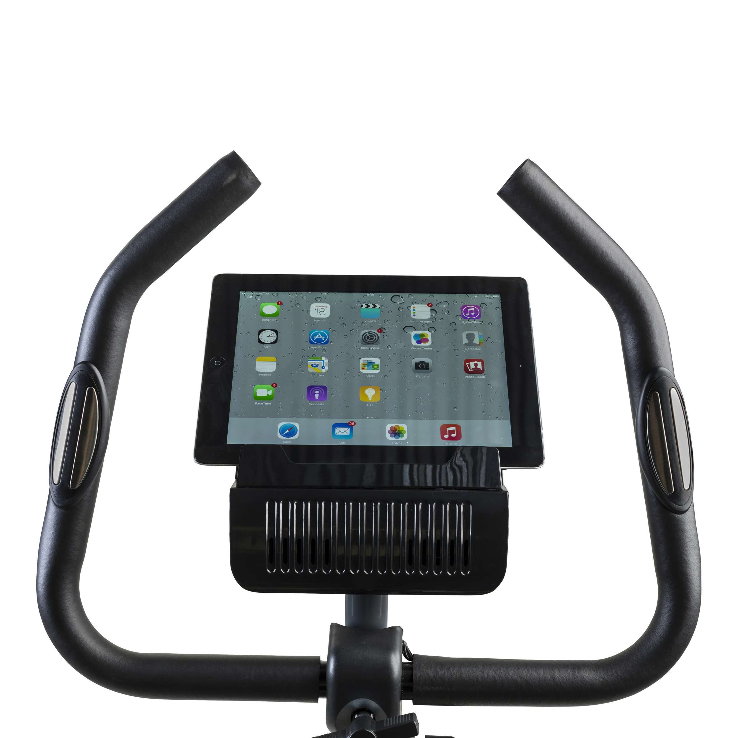 An exercise bike's handlebars with an iPad displaying app icons. The bike is black with a white background.
