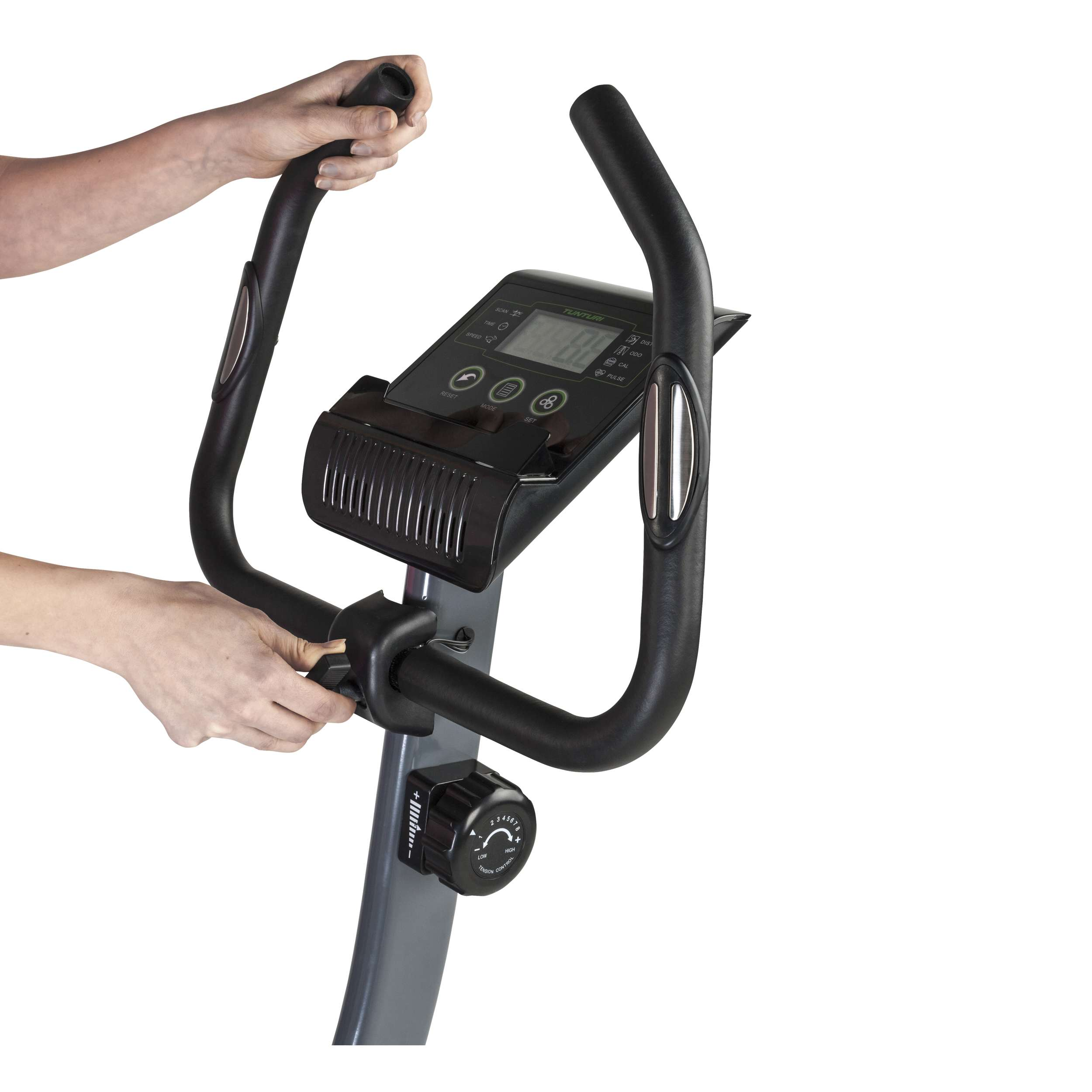 Hands on a stationary bike's handlebars. Display shows numbers. Black and gray colors dominate the bike's design.