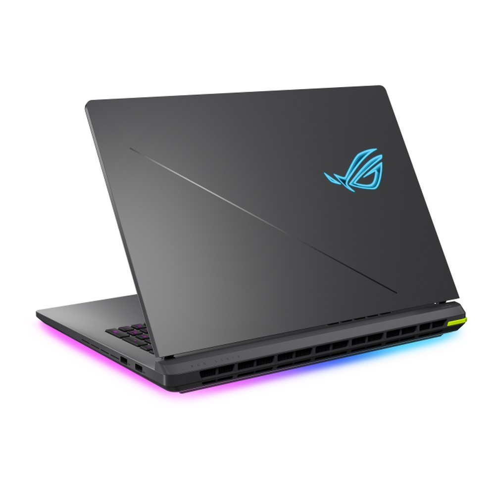 Un laptop grigio è leggermente aperto, mostrando la tastiera. Il coperchio ha un logo blu brillante. Il bordo inferiore ha luci colorate.