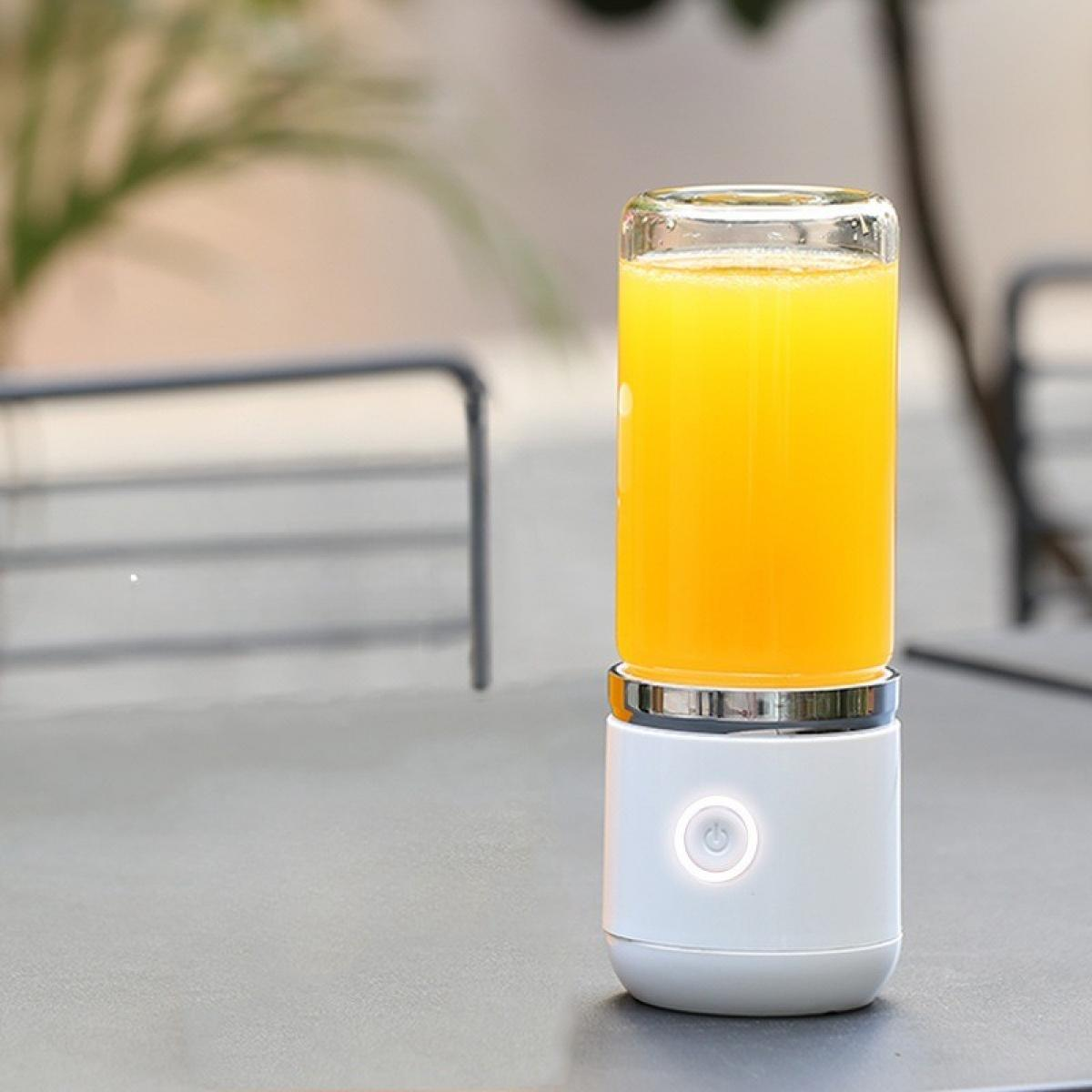 Ein weißer tragbarer Mixer mit Orangensaft. Es steht auf einem Tisch. Der Hintergrund hat eine verschwommene Außenansicht.