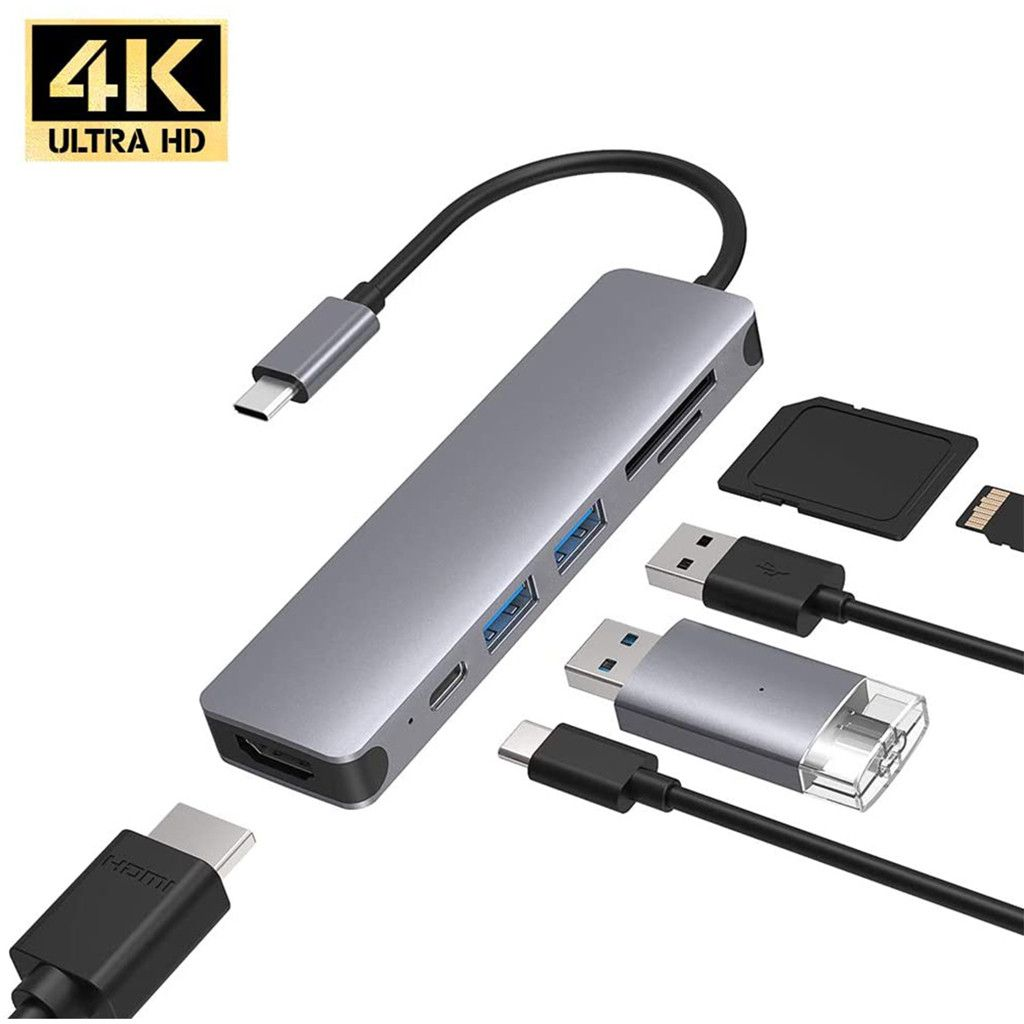 Ein grauer USB-Hub mit mehreren Anschlüssen, darunter USB-A, USB-C und HDMI. Ein 4K Ultra HD-Logo befindet sich oben links.