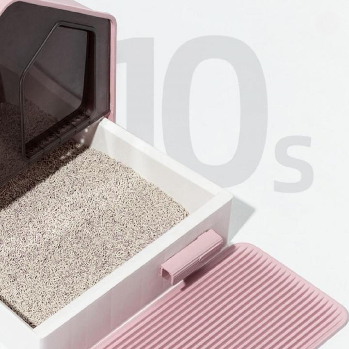 Rosa Katzenstreu-Box, offen, mit Streu gefüllt. Ein rosa Griff und eine Matte sind sichtbar. Der Hintergrund hat das Wort "10s" in Grau.