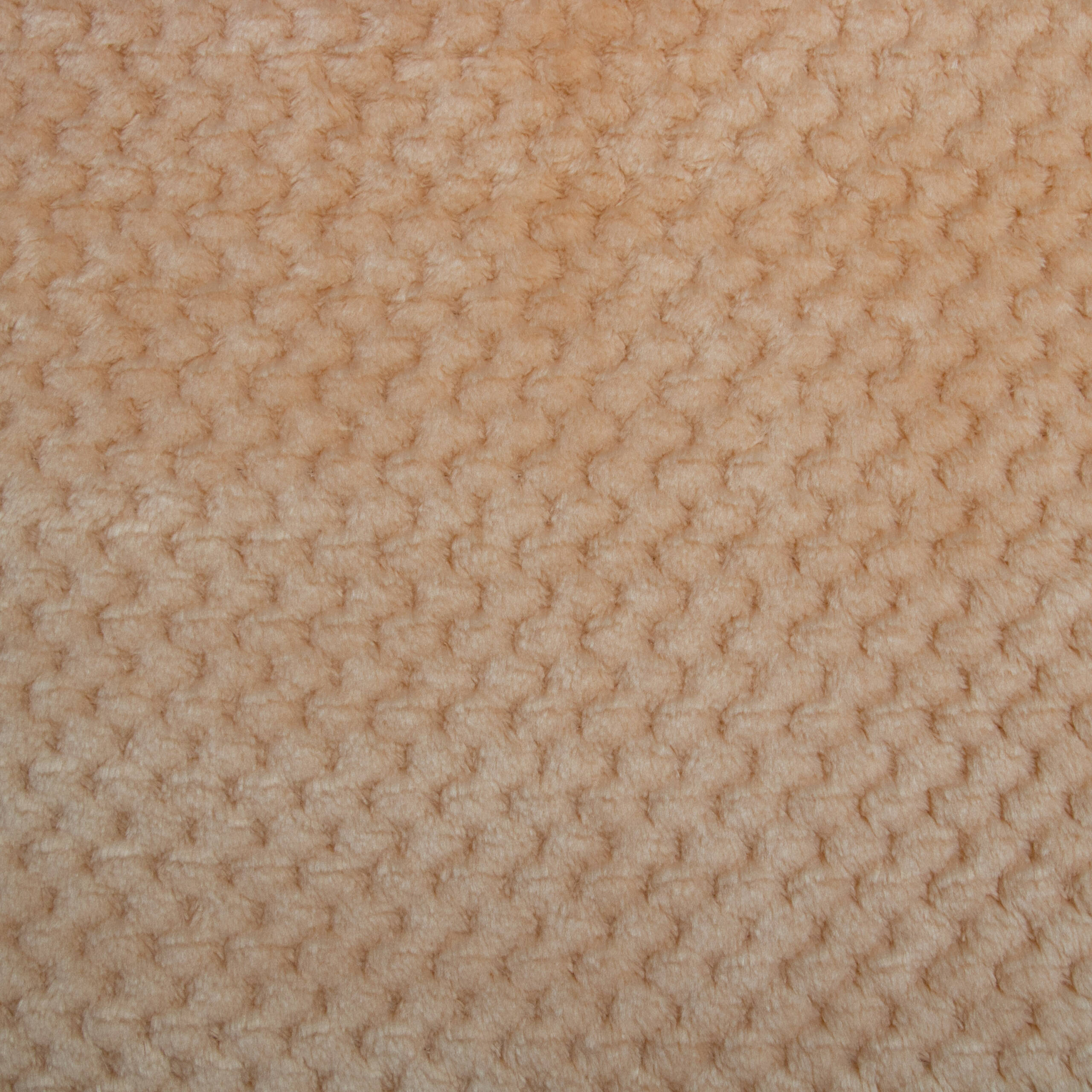 Primo piano di tessuto beige strutturato. La superficie presenta un motivo di piccole forme arrotondate in rilievo.