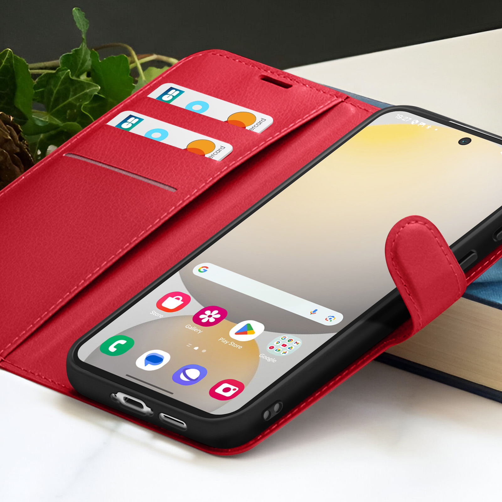 Een rode telefoonhoes met een smartphone. Er zitten kaarten in de hoes. De telefoon toont app-iconen.