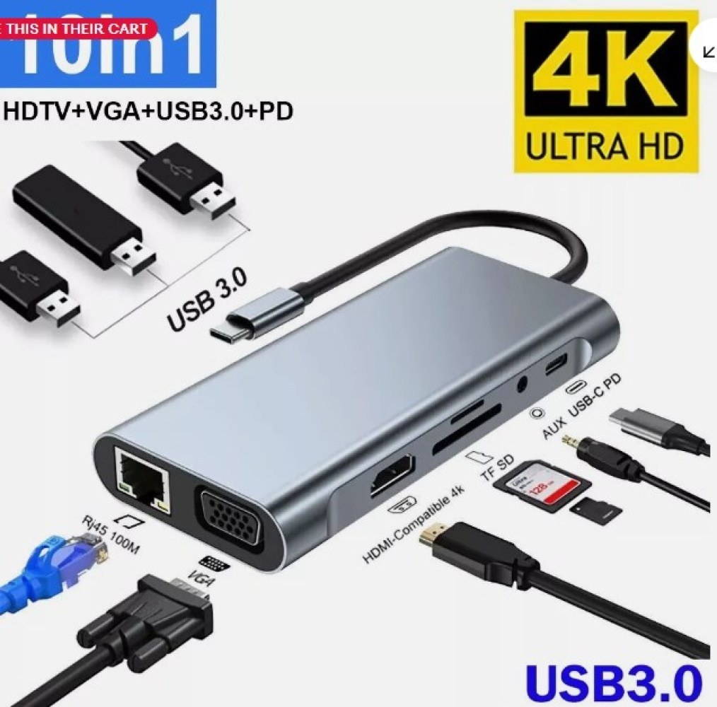 Ein silberner USB-Hub mit mehreren Anschlüssen, darunter HDMI, VGA und USB 3.0, mit Kabeln und einem 4K Ultra HD Logo.