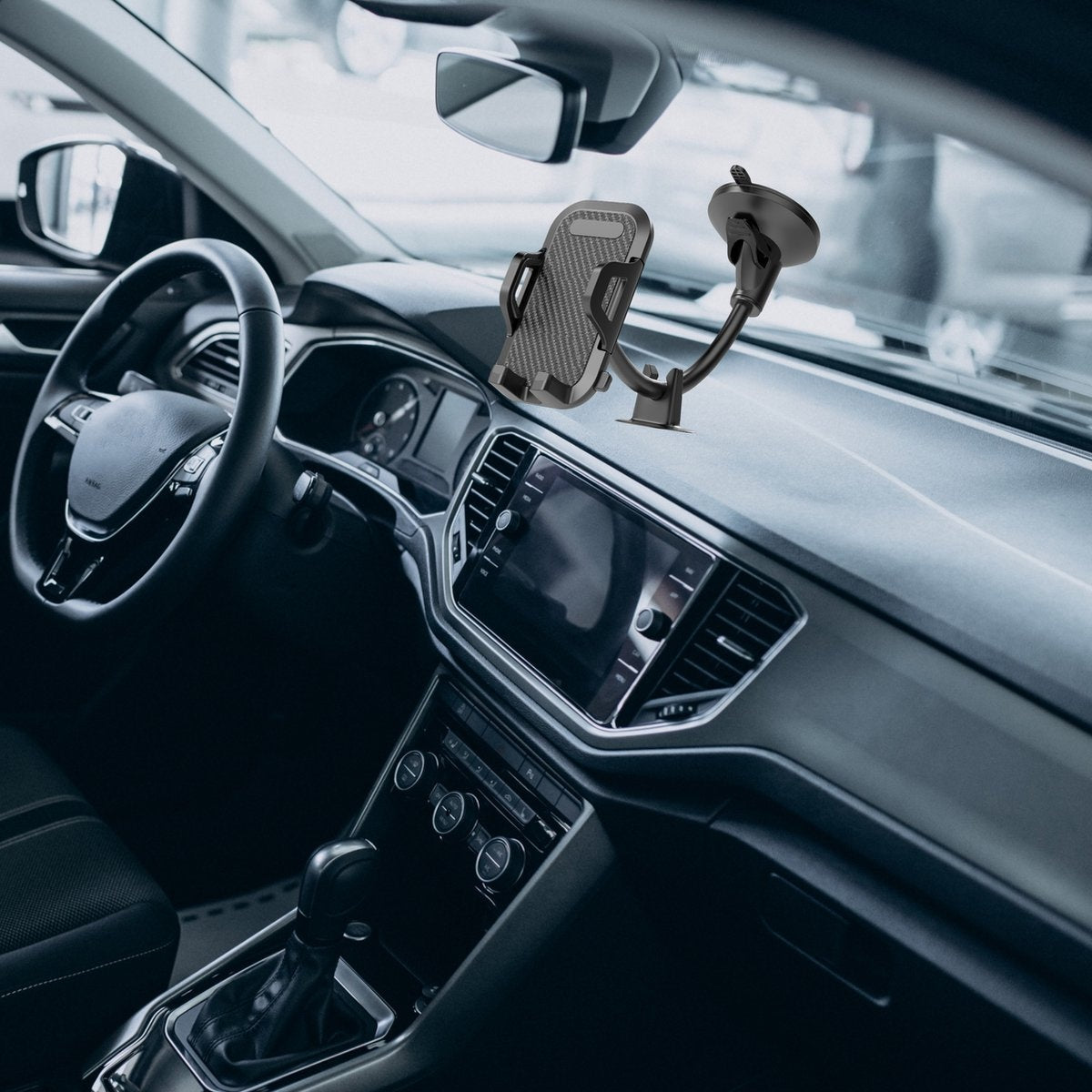 Car interior with phone holder mounted on dashboard. Steering wheel, display, and gear shift are visible. Car details.
