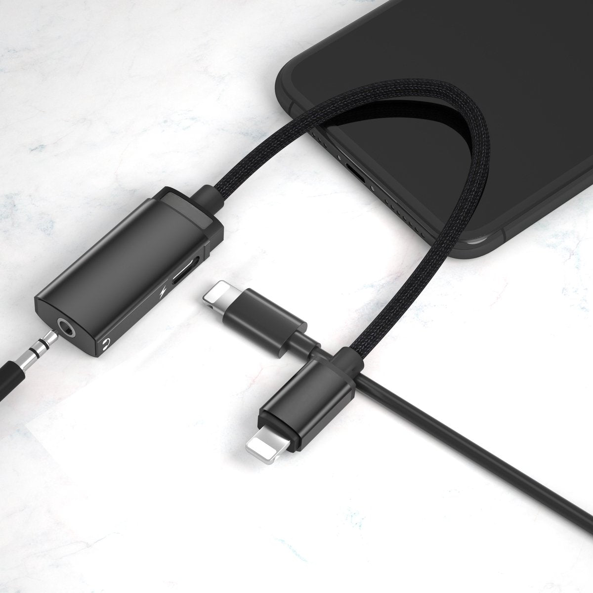 A black adapter with a lightning connector, a 3.5mm jack, and a phone.