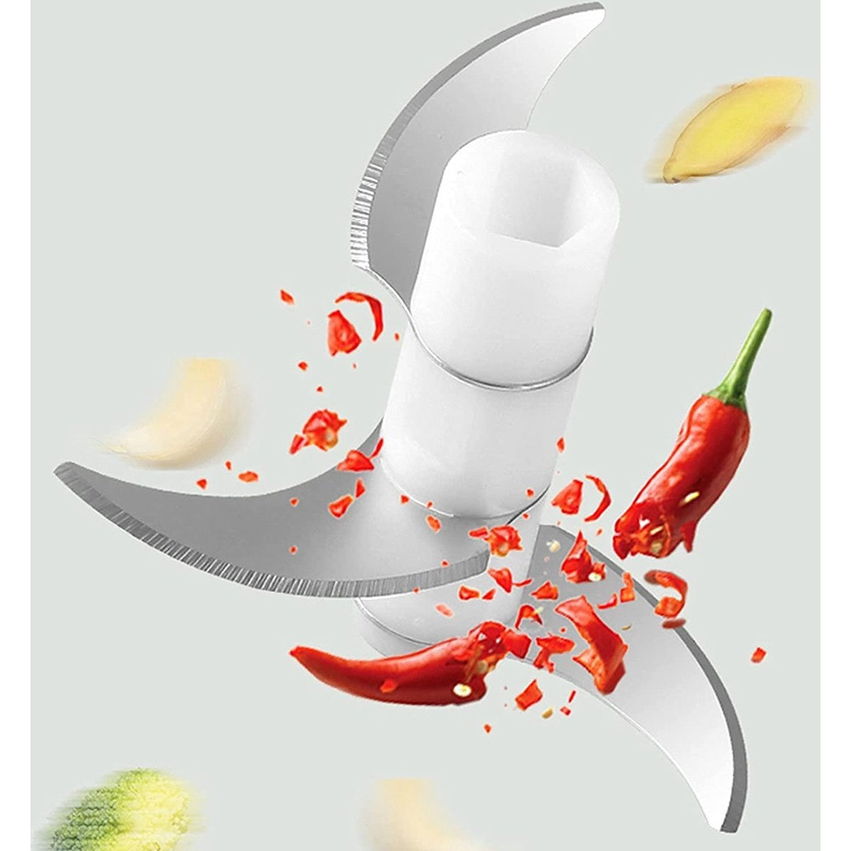 A food processor with blades chopping red chilies and white garlic. Slices of ginger and a green vegetable are also present.