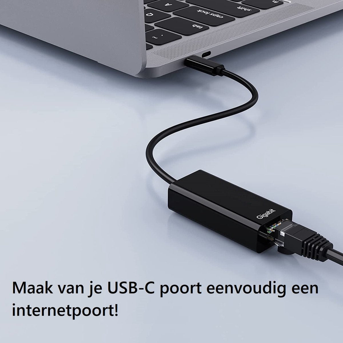 A black USB-C to Ethernet adapter connected to a laptop. The adapter says Gigabit. The text below reads: Make your USB-C port an internet port!