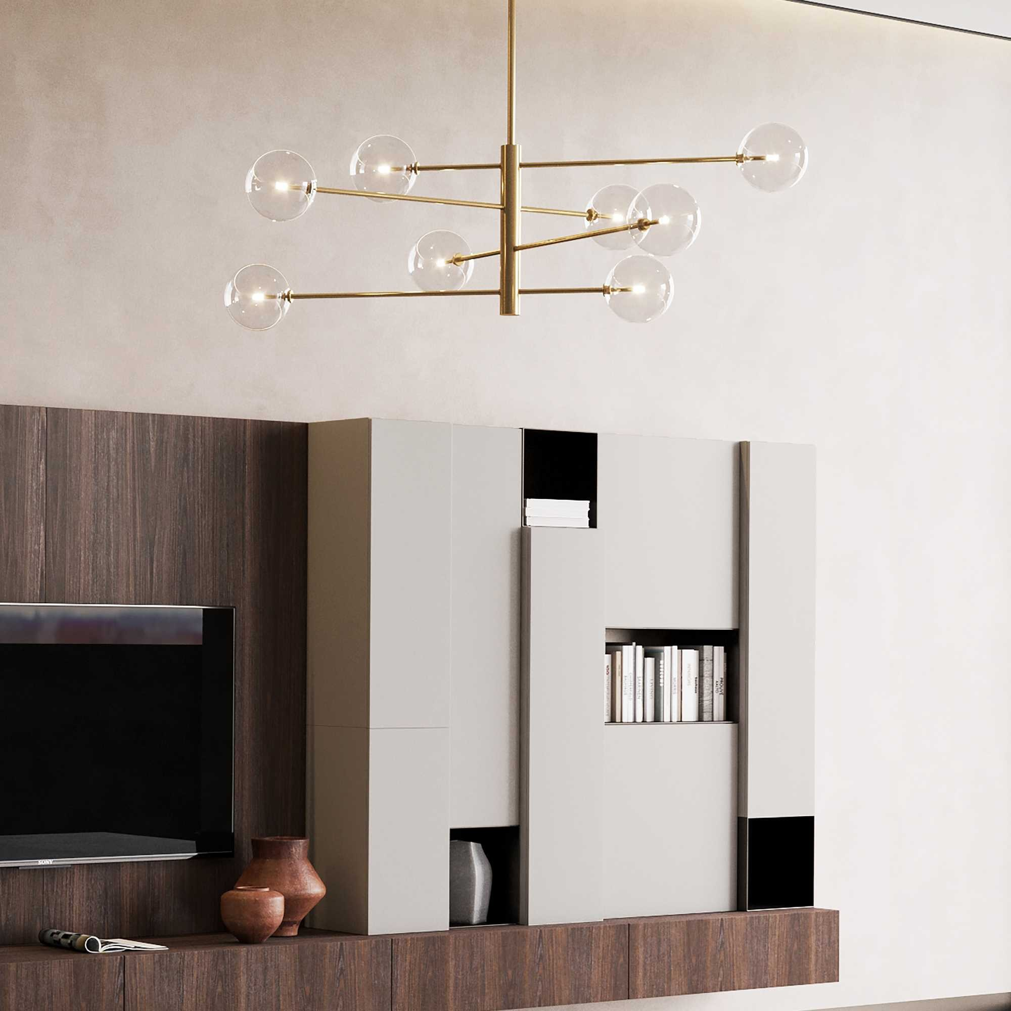 Soggiorno moderno con lampadario, armadi e TV. Pannelli in legno marrone contrastano con armadi grigi e bianchi.