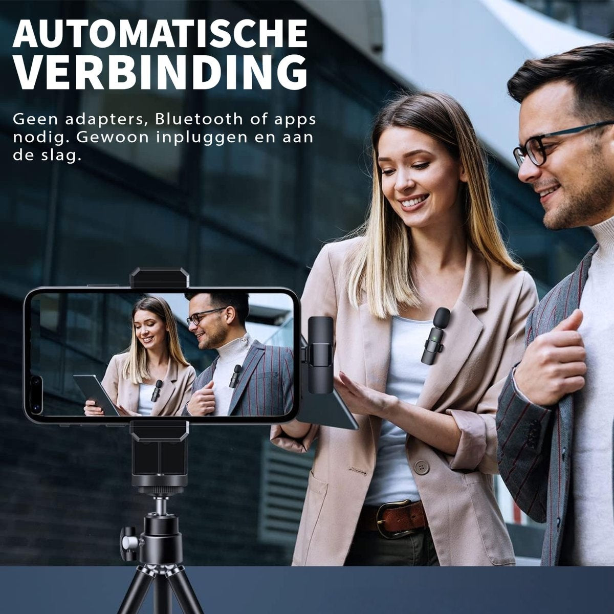 A woman and a man are looking at a phone with a tripod. The phone displays the same two people. Microphones are on their jackets.