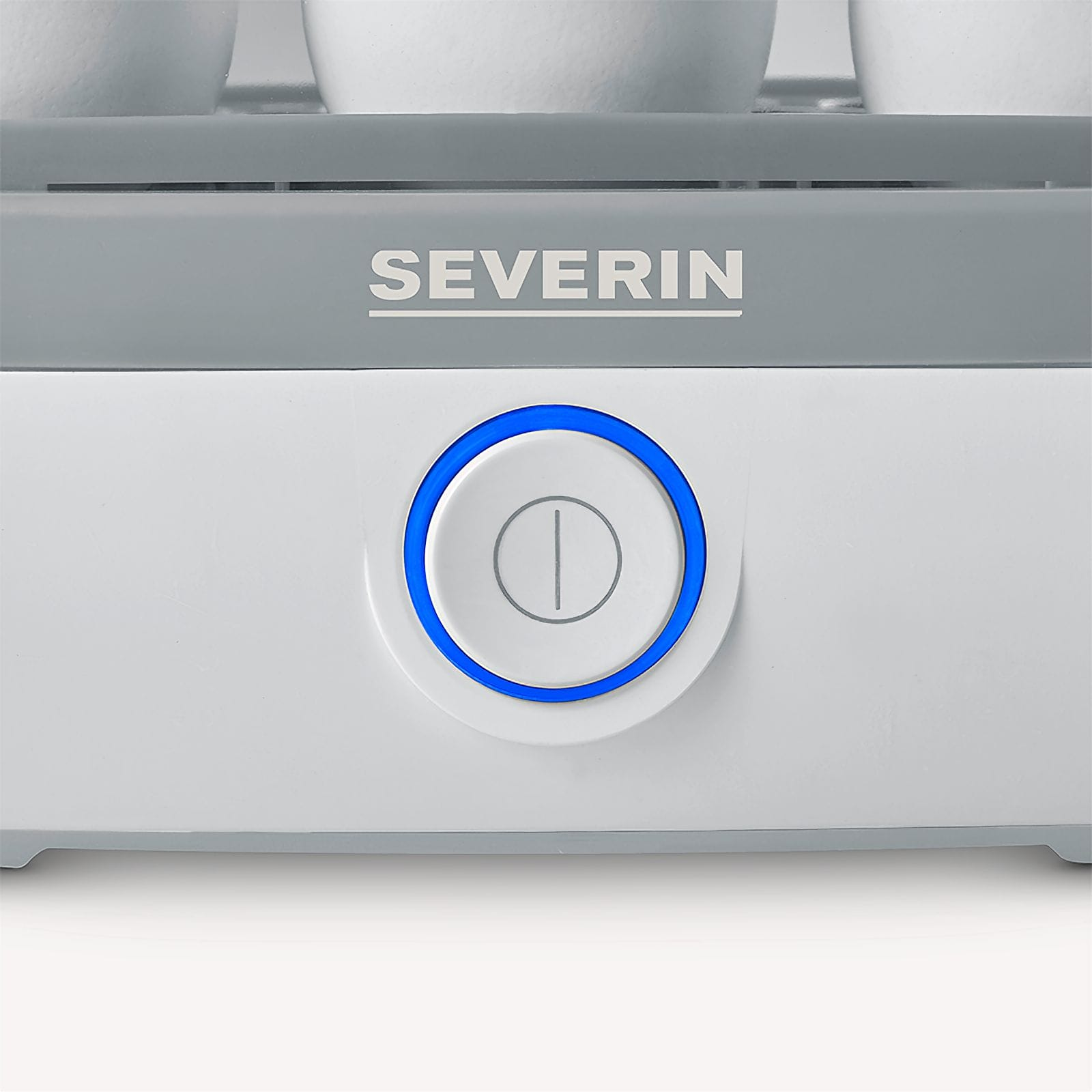 Zbliżenie białego urządzenia. Posiada przycisk z niebieskim pierścieniem i napisem SEVERIN.