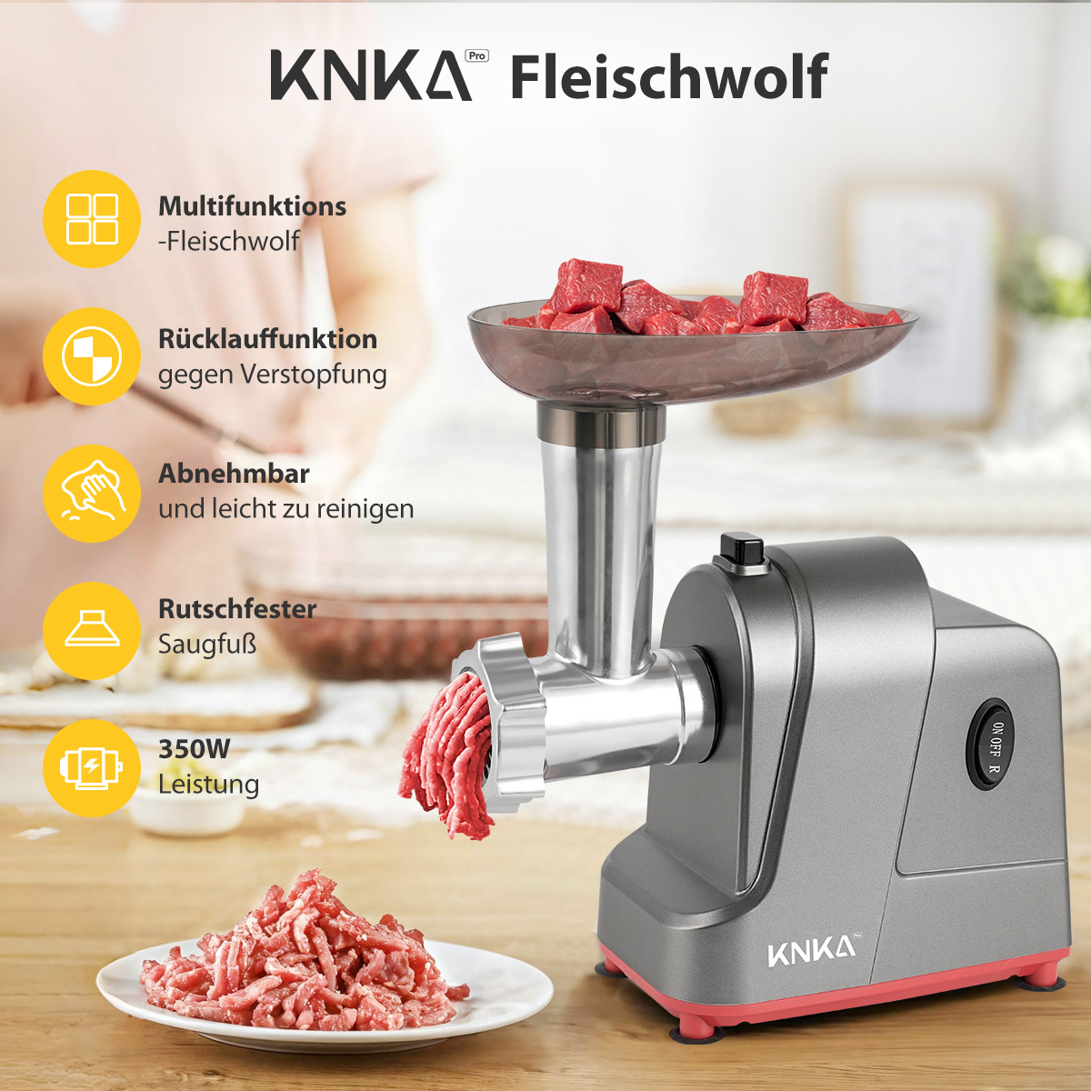 Ein grauer und roter Fleischwolf wird gezeigt. Rohe Fleischwürfel sind in der Schüssel, Hackfleisch kommt heraus. Merkmale sind mit Symbolen aufgelistet.