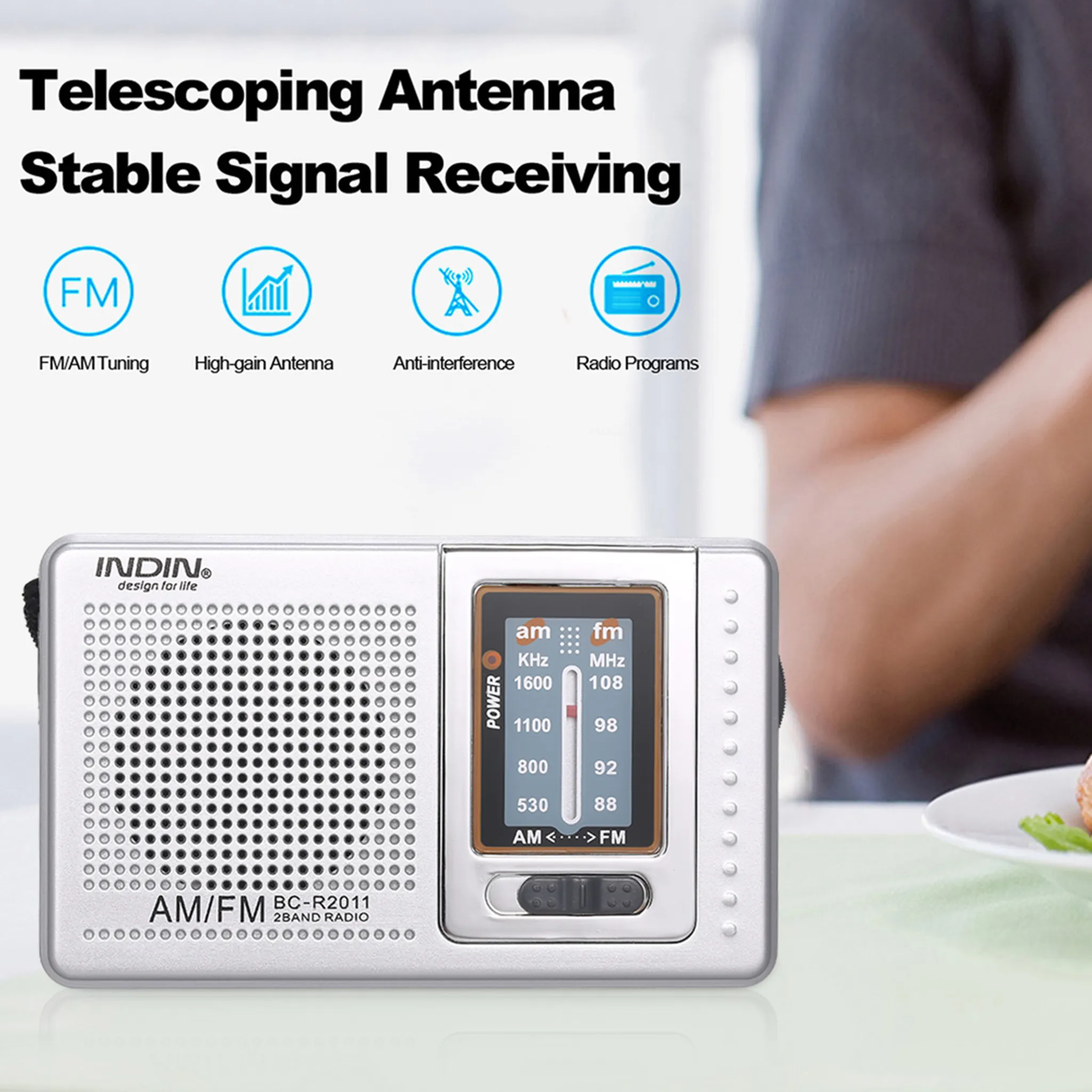 Silbernes AM/FM-Radio mit Display. Oben steht: 'Teleskopantenne Stabiler Signalempfang'.