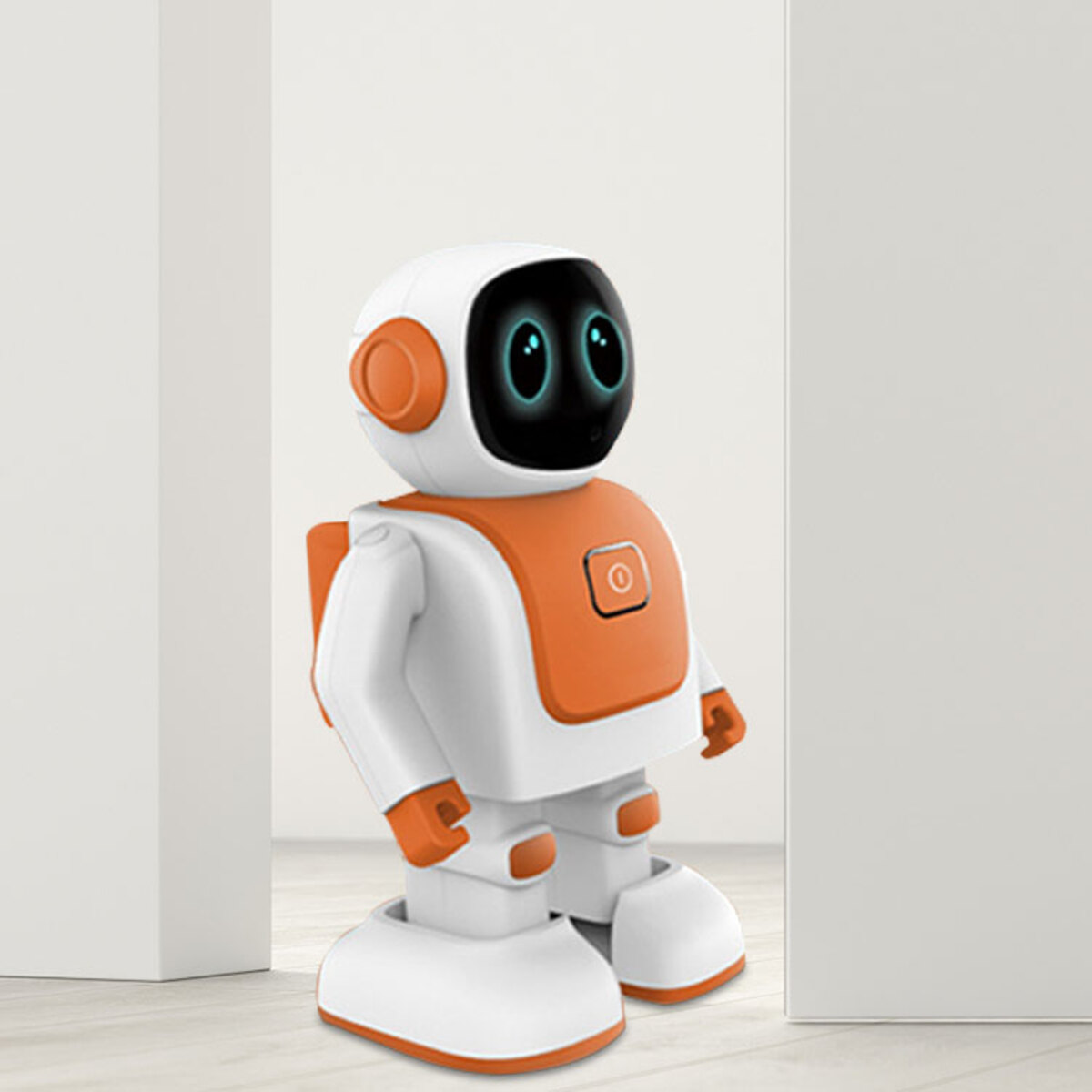 Un robot blanco y naranja está entre dos paredes blancas. El robot tiene una cara negra con ojos brillantes y un botón de encendido.