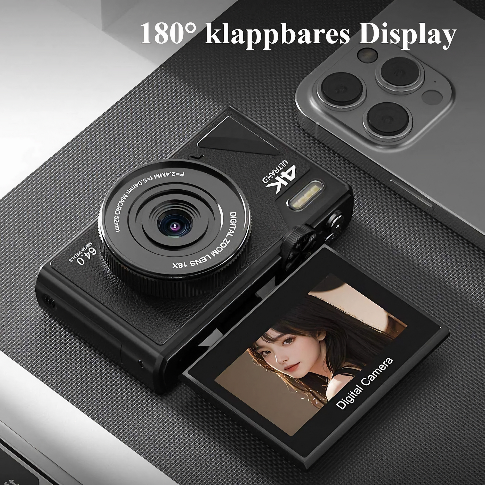 Eine schwarze Digitalkamera mit ausklappbarem Bildschirm, der das Bild einer Frau zeigt. Daneben liegt ein Telefon. Text: '180° klappbares Display'.