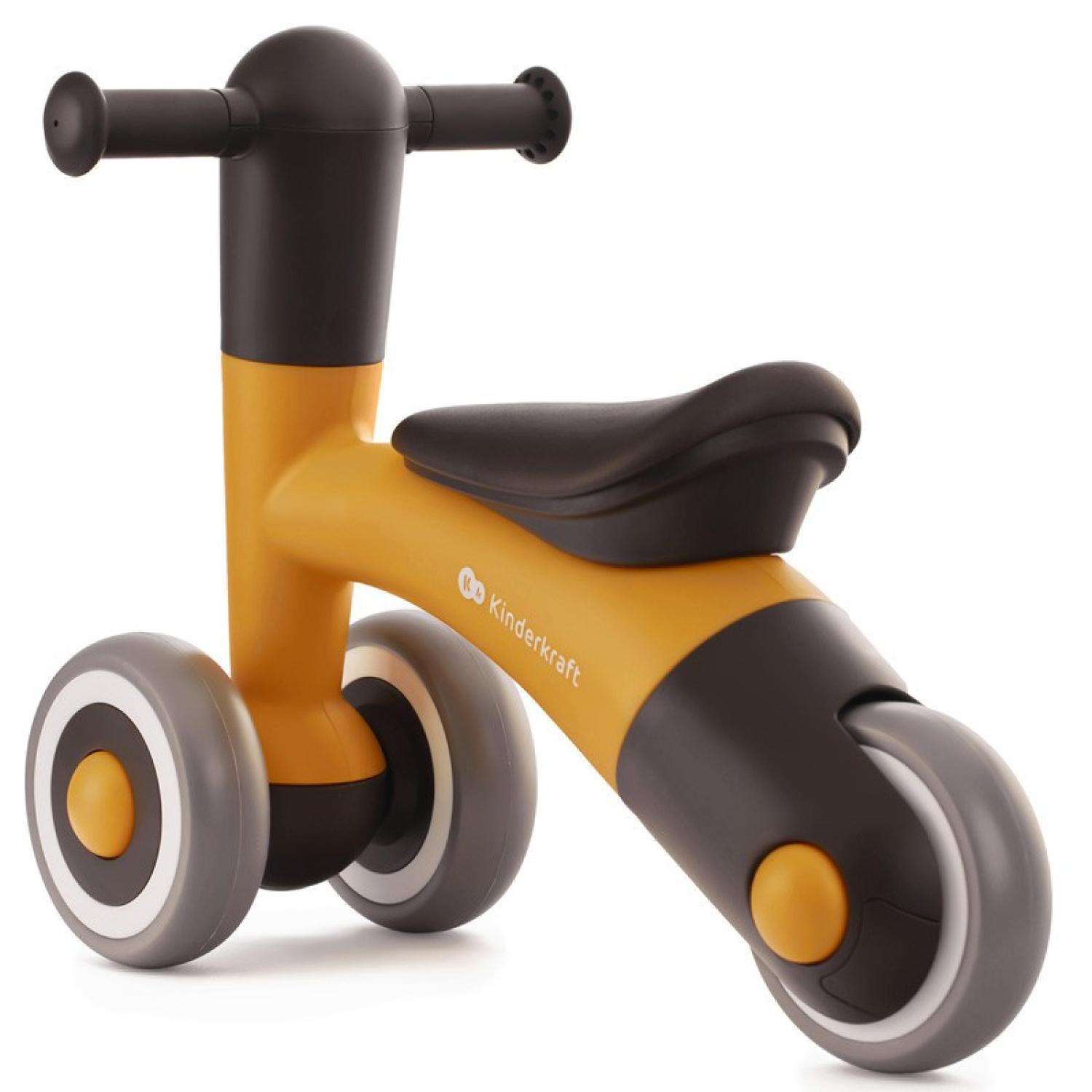 Una bici senza pedali Kinderkraft gialla e nera con ruote grigie. Ha un piccolo sedile e manubrio.