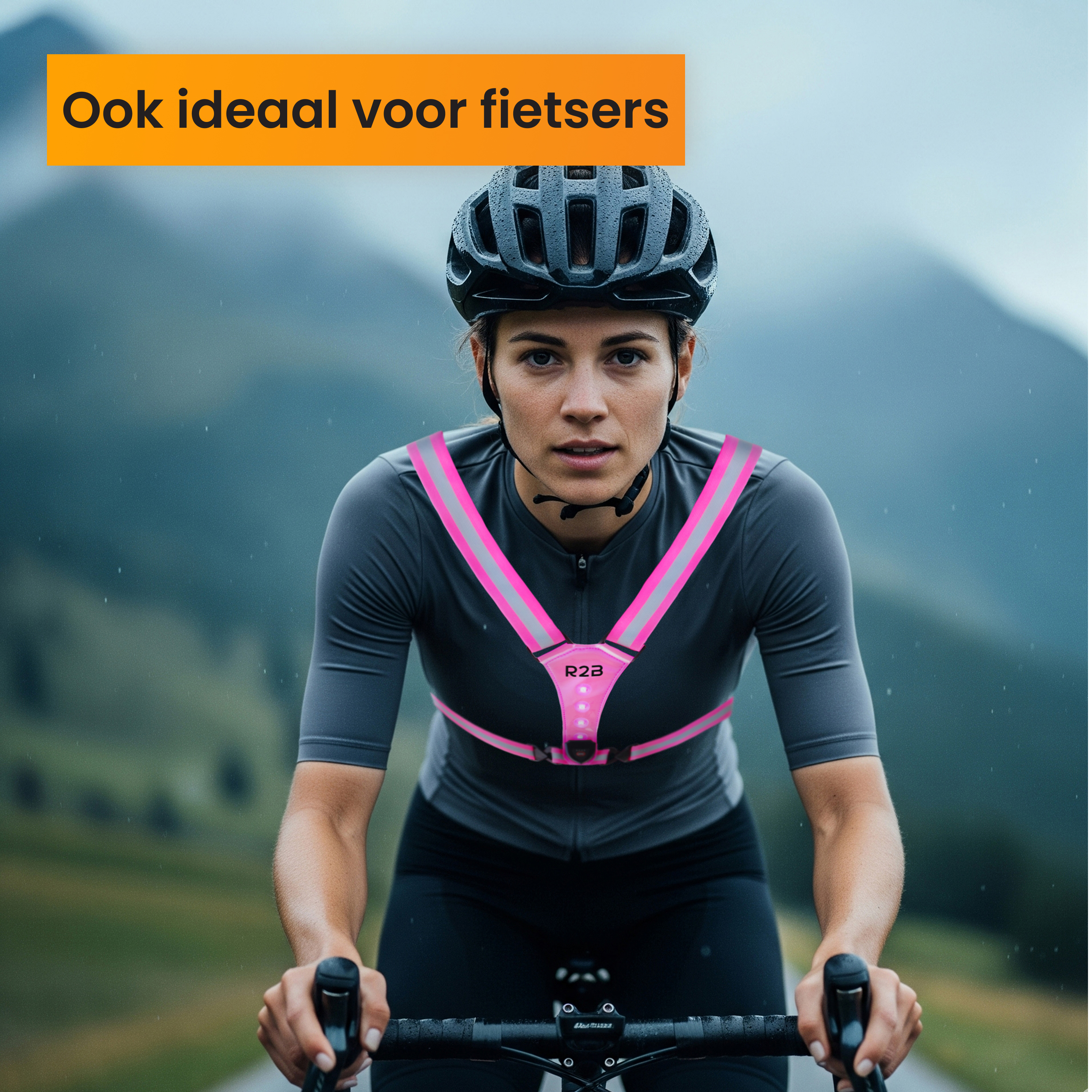 A woman on a bike wearing a helmet and a pink reflective vest. It's raining. The background is blurred mountains.
