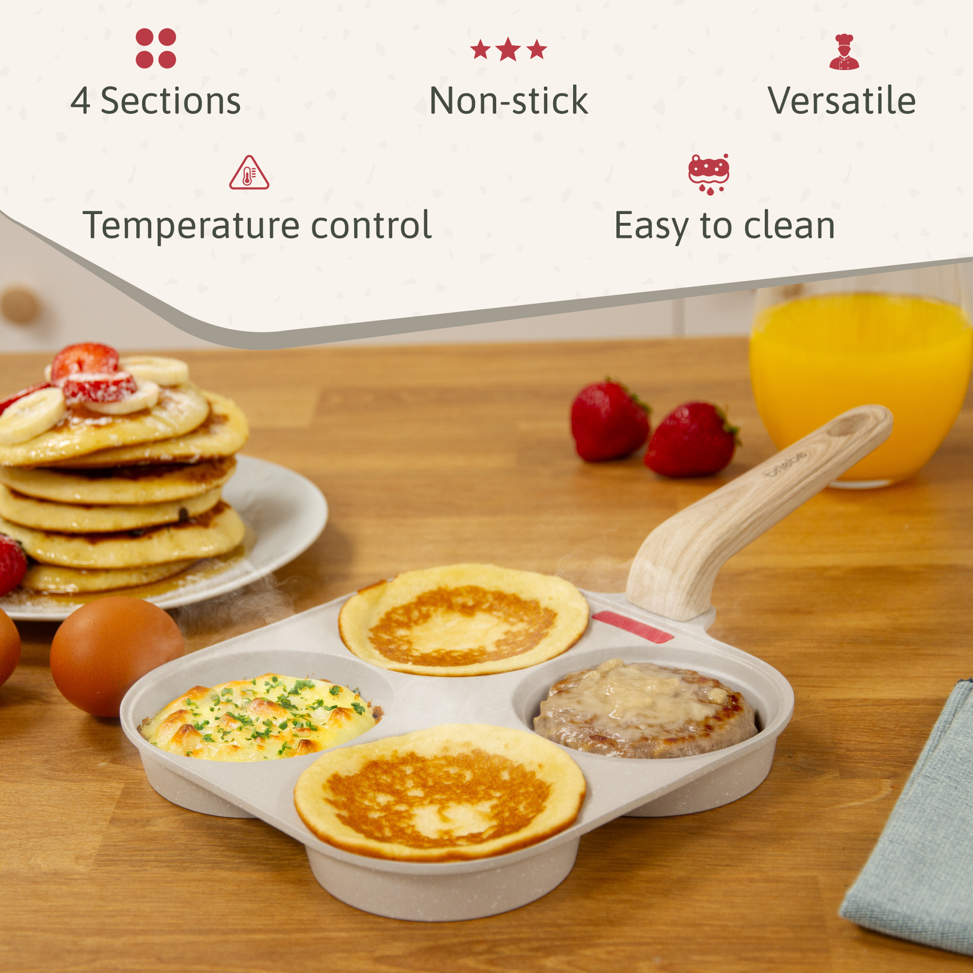 Una sartén de varias secciones con panqueques, huevos y una hamburguesa cocidos. También, panqueques, huevos, fresas y jugo de naranja.