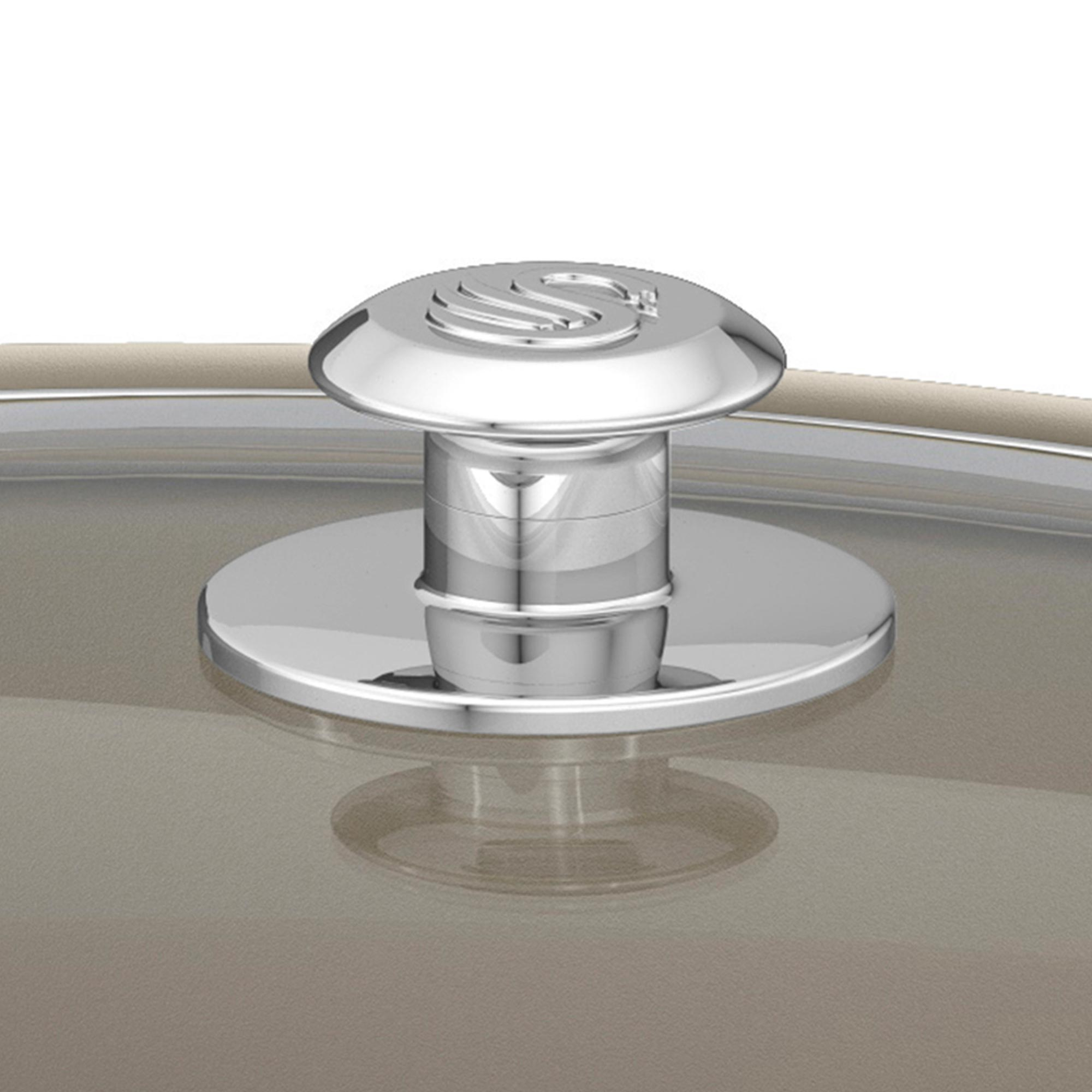 Nahaufnahme eines verchromten Topfdeckelgriffs mit dem Swan-Logo. Der Griff befindet sich auf einem Glasdeckel über einem Topf.